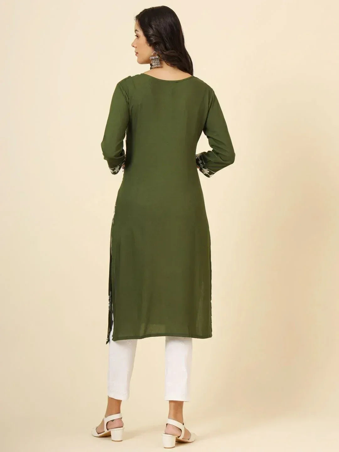 Woman wearing olive green kurti with white pants, traditional ethnic fashion back view