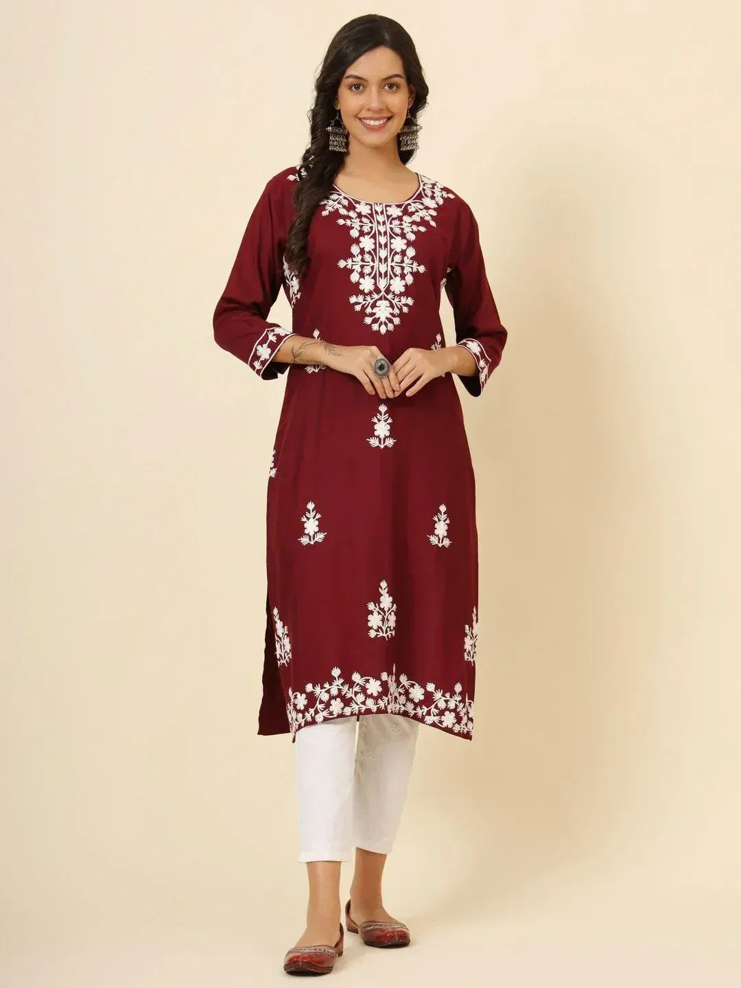 Maroon ethnic kurti with white floral embroidery, paired with white pants for a stylish look.