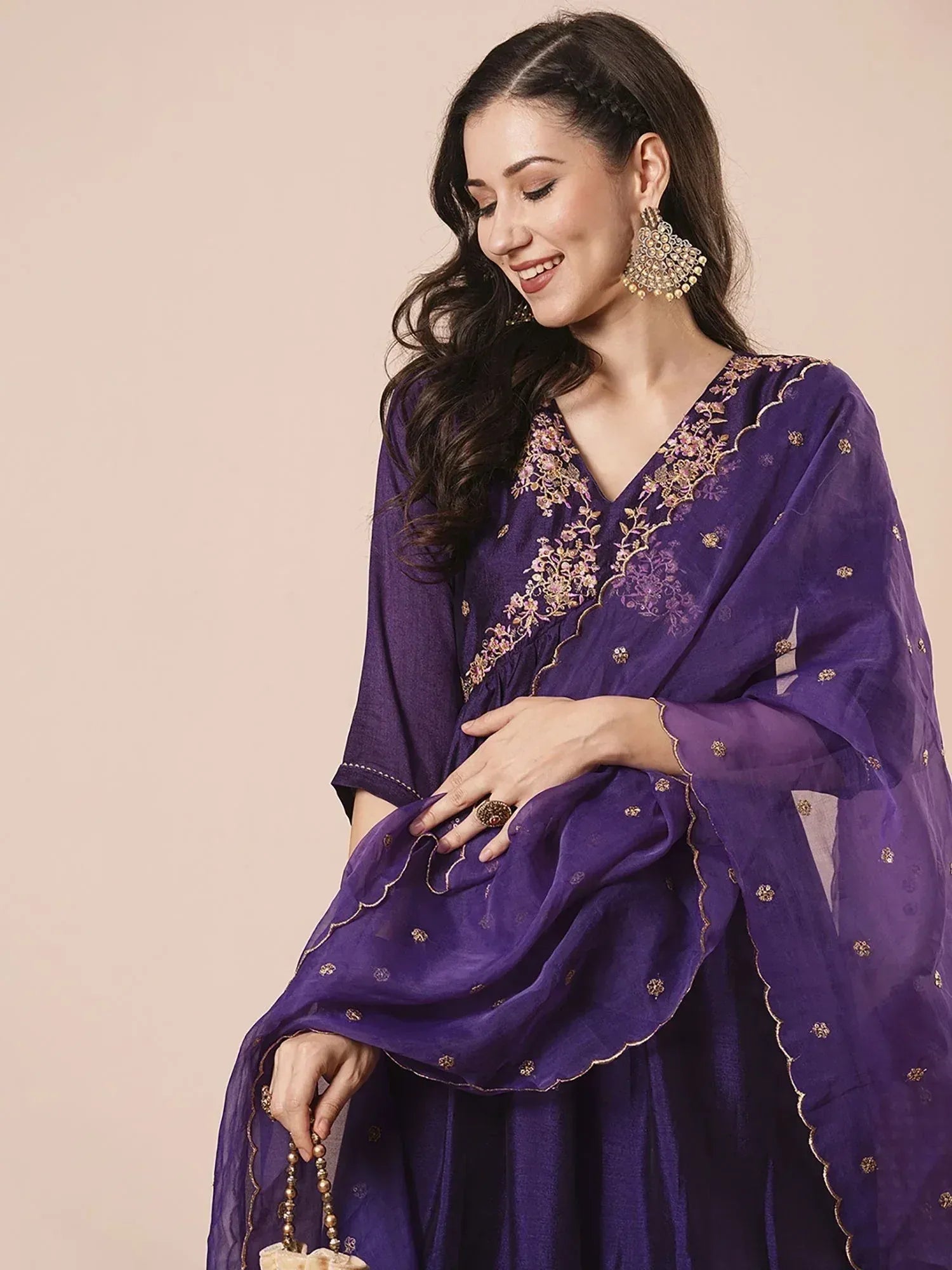 Purple embroidered salwar kameez with gold floral detailing, perfect for Indian ethnic wear occasions