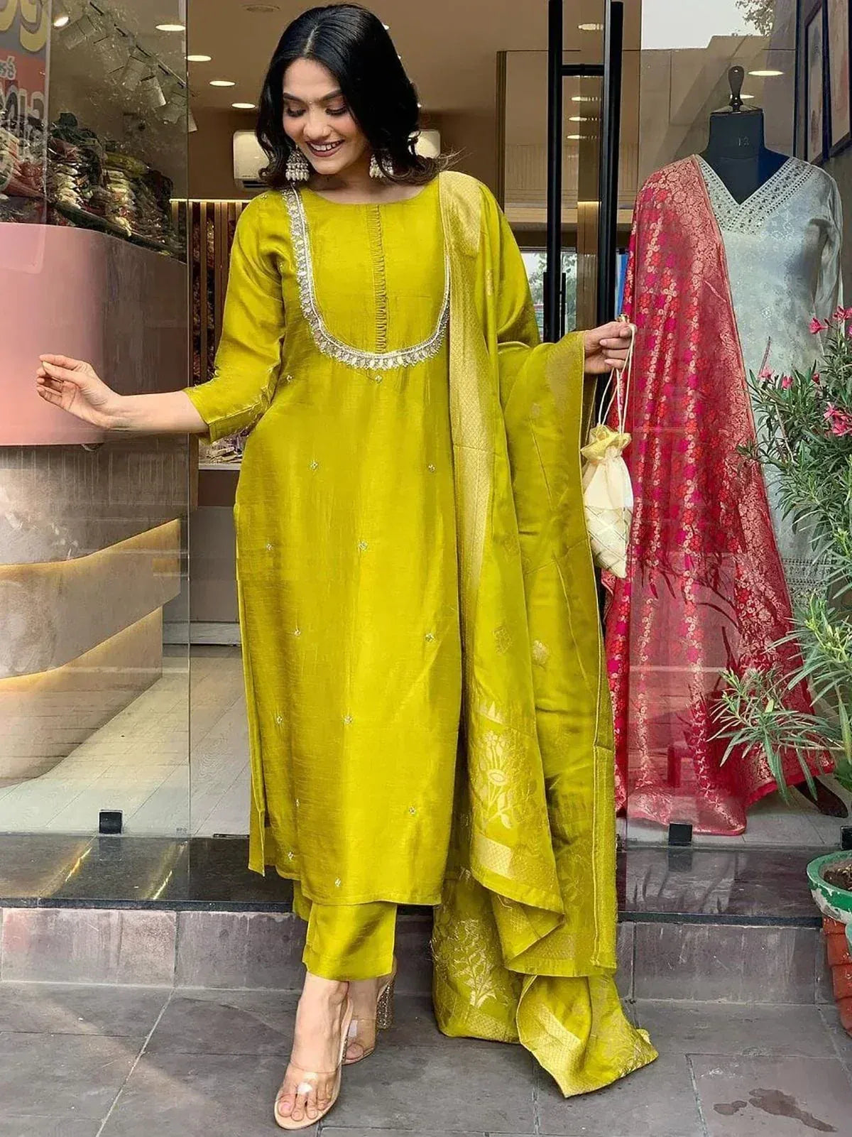 Vibrant yellow ethnic salwar kameez with embroidered neckline and matching dupatta, perfect for festive occasions.