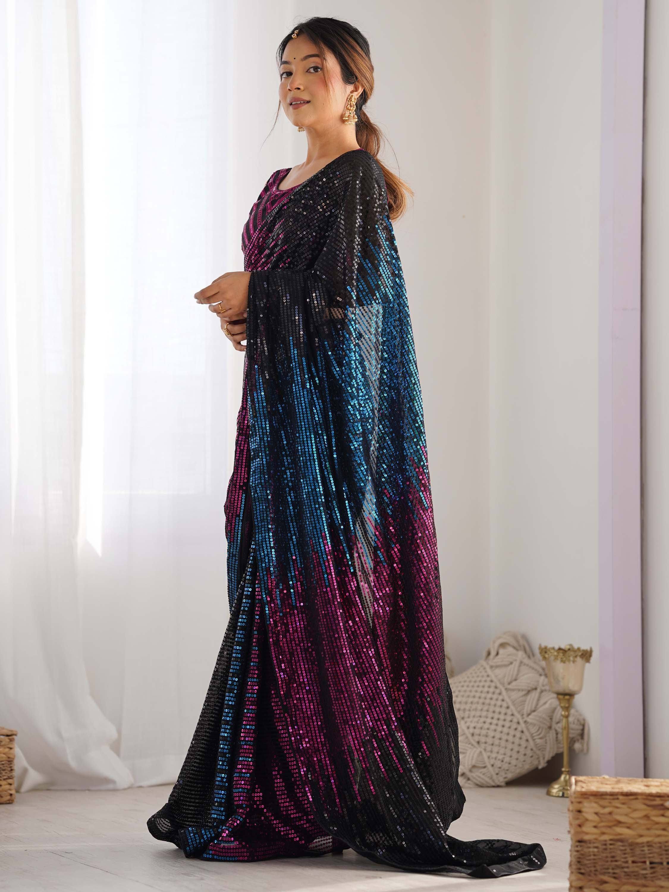 Woman in black, blue, and pink sequin ethnic gown, perfect for Indian festive occasions and parties.