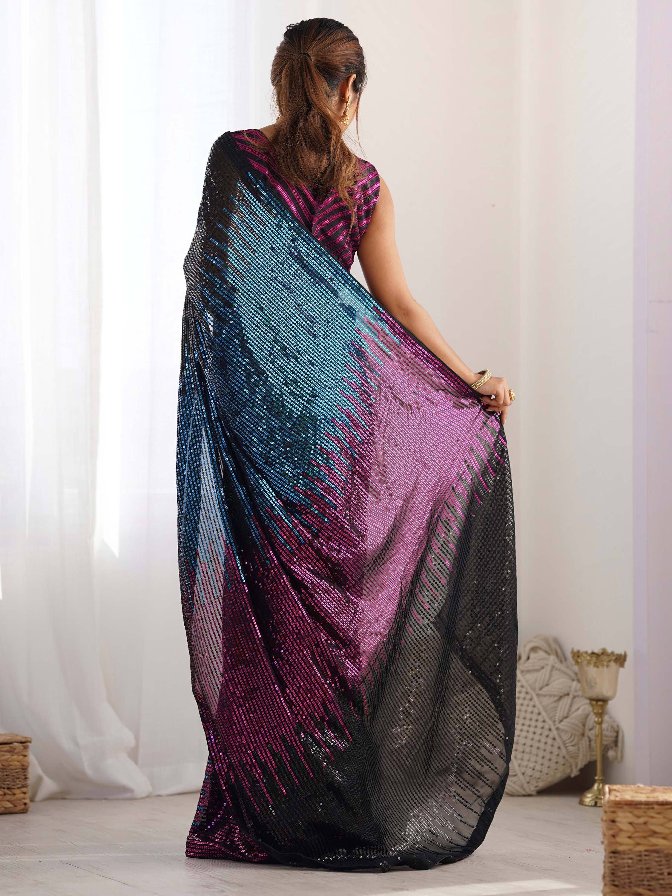 Woman in vibrant sequin saree with blue pink black ombre design, ethnic wear for parties