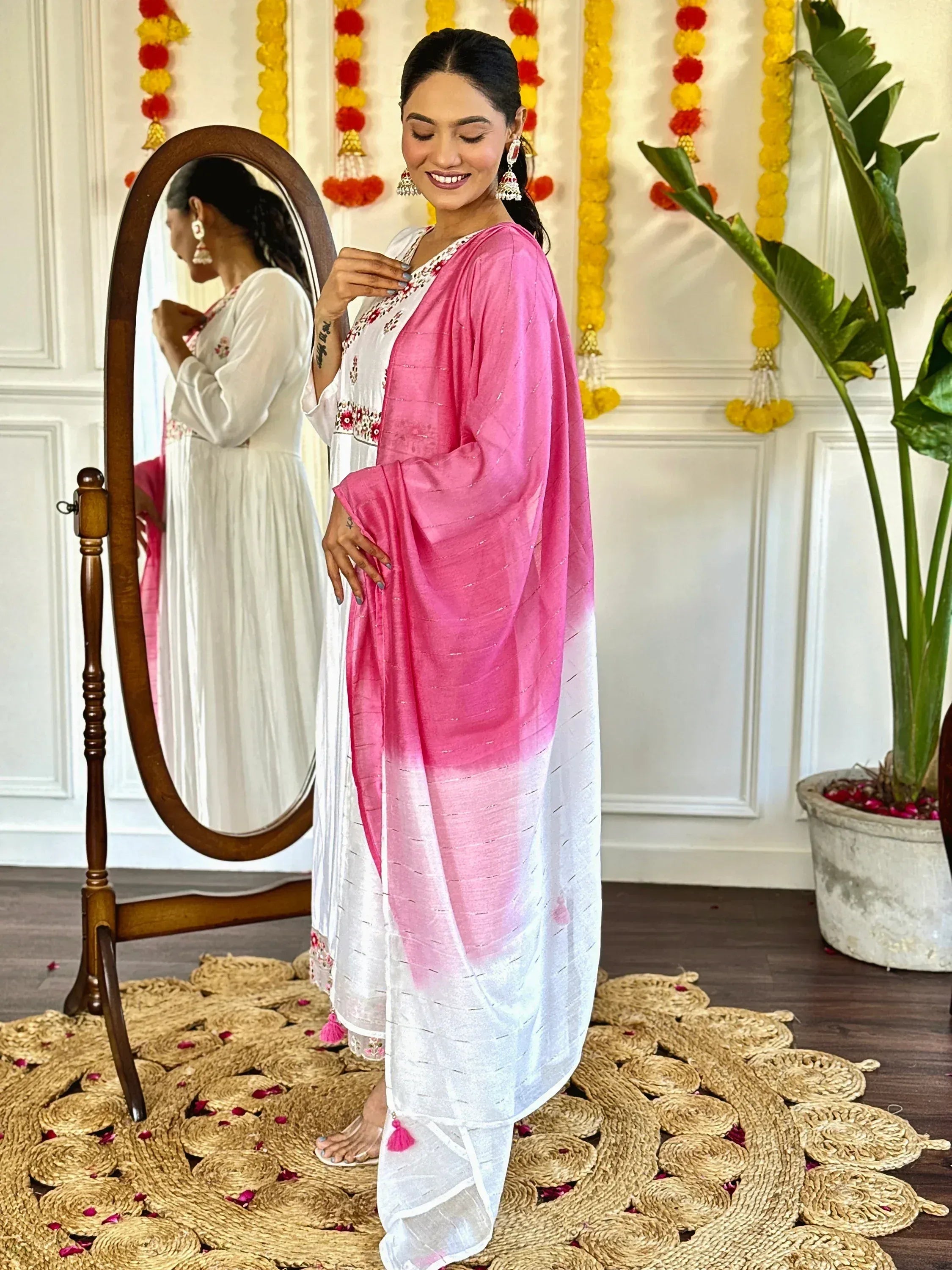 Woman in white embroidered kurta with pink ombre dupatta, festive Indian ethnic wear