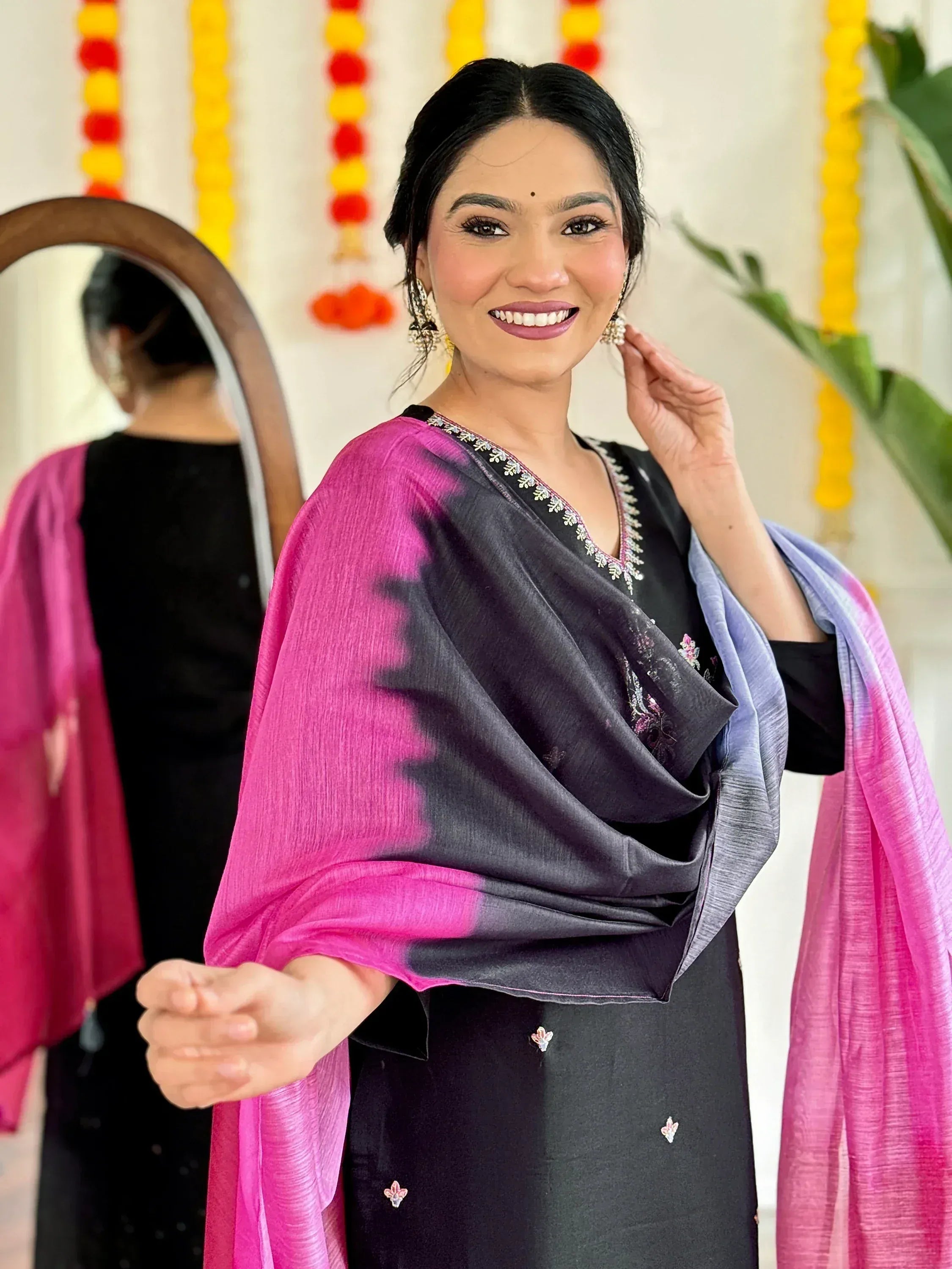 Woman in black embroidered salwar kameez with pink-purple ombre dupatta, festive Indian ethnic wear
