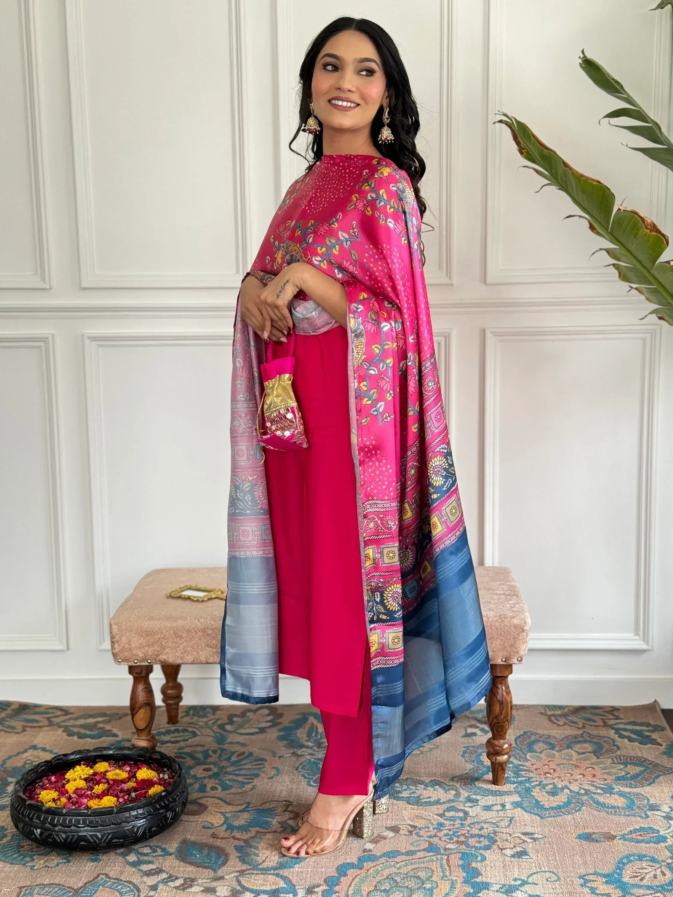Woman in vibrant pink salwar kameez with floral dupatta, perfect for Indian ethnic occasions