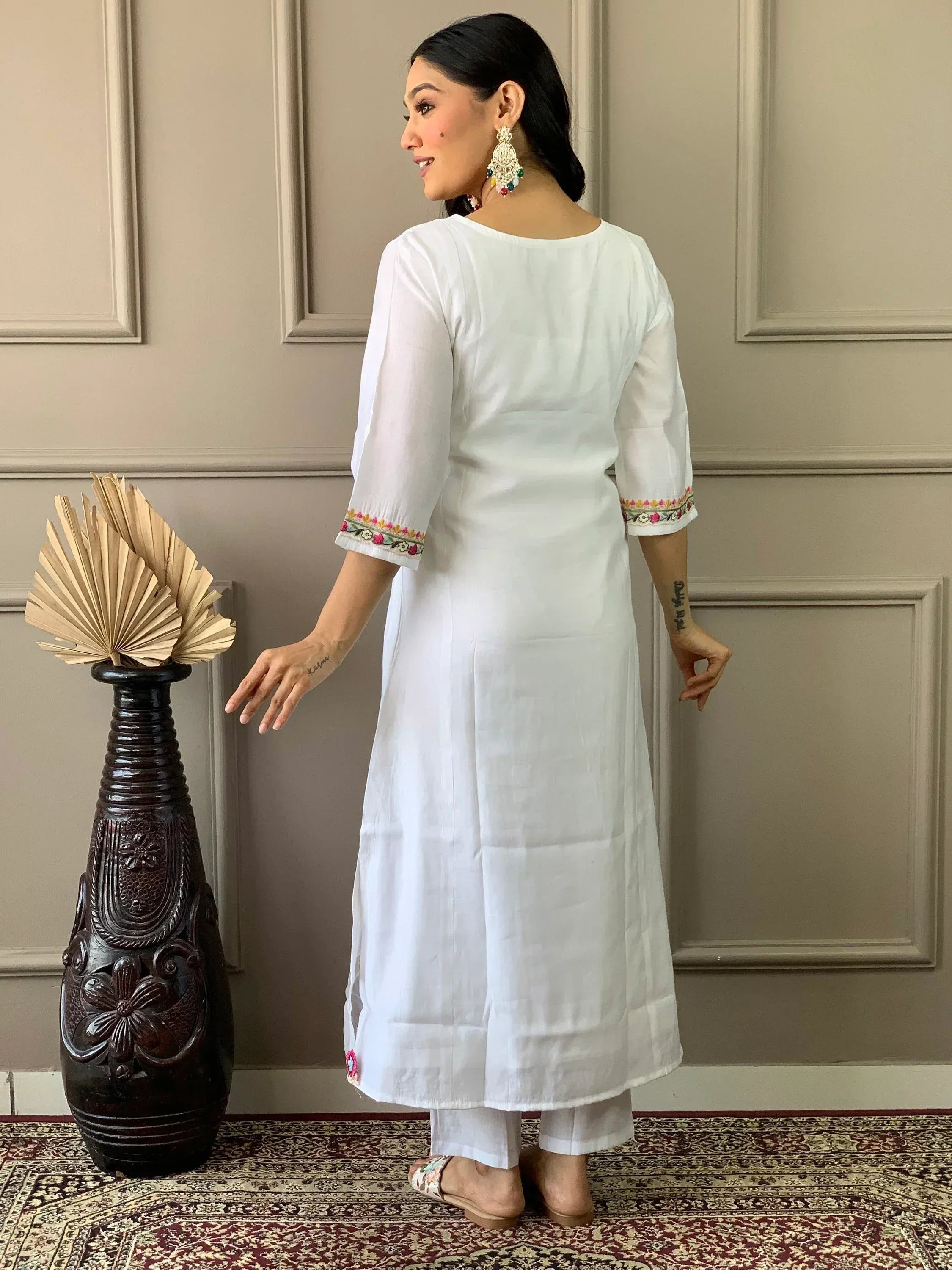 White embroidered kurta with floral detailing, paired with palazzo pants, ideal for ethnic wear occasions.