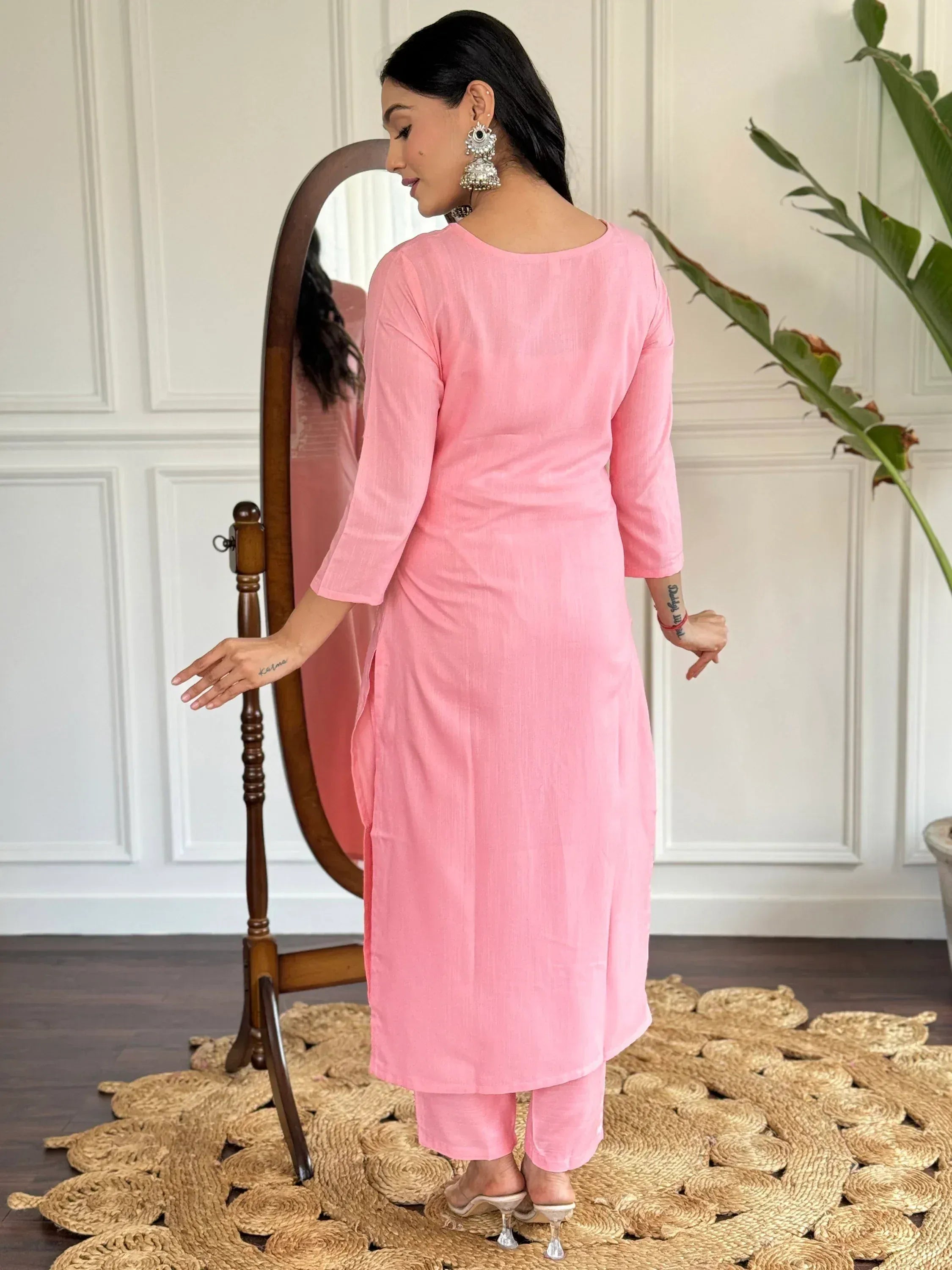 Pink ethnic kurta set with matching pants, styled with jhumka earrings and heels for Indian wear