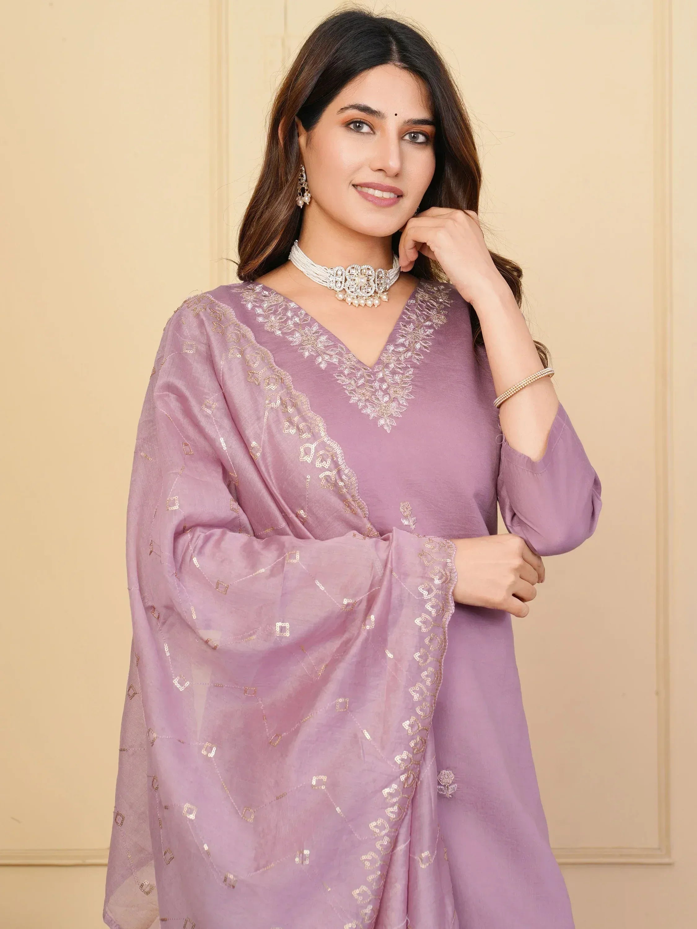 Lavender ethnic kurta with gold embroidery and matching dupatta, styled with pearl jewelry