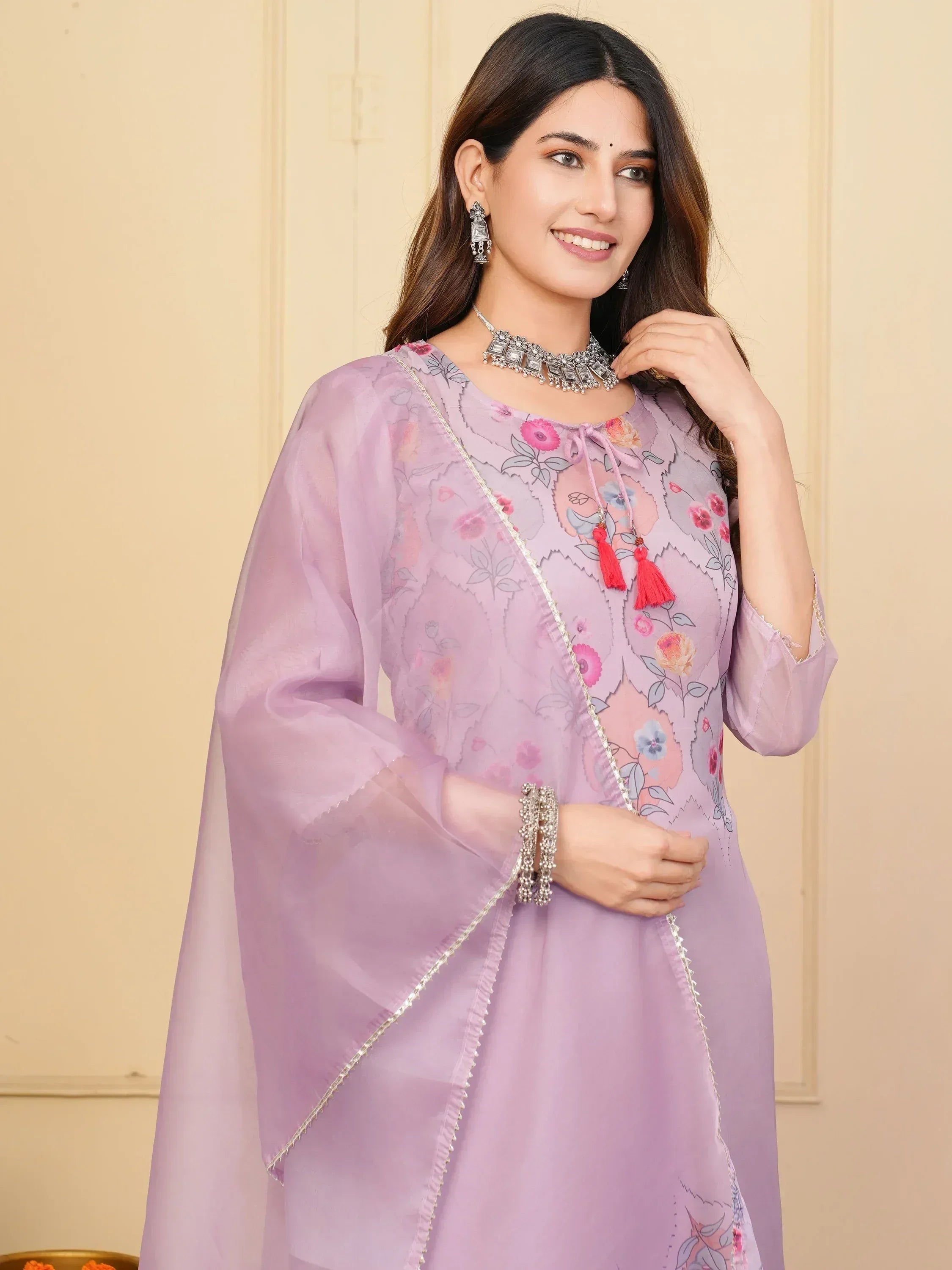 Lavender floral printed ethnic kurta with sheer sleeves and tassels, paired with silver jewelry
