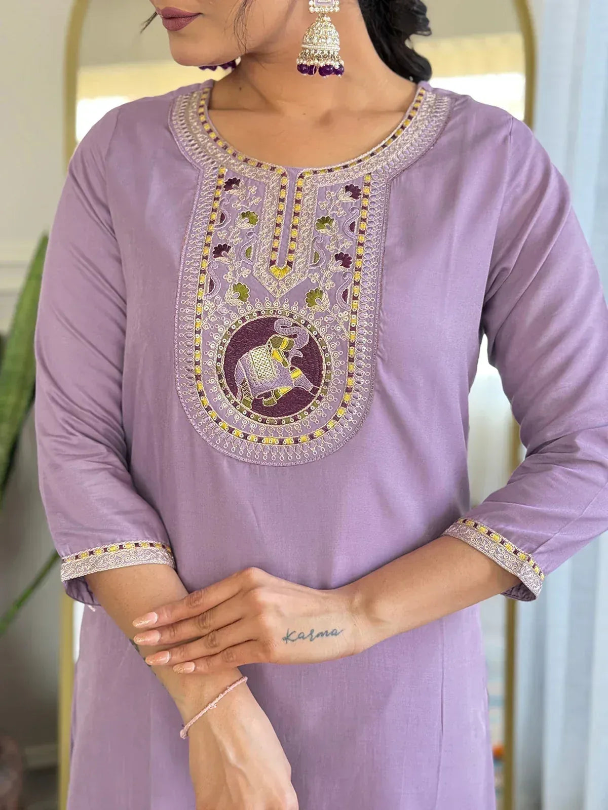 Lavender ethnic kurti with elephant embroidery and gold detailing, paired with statement earrings