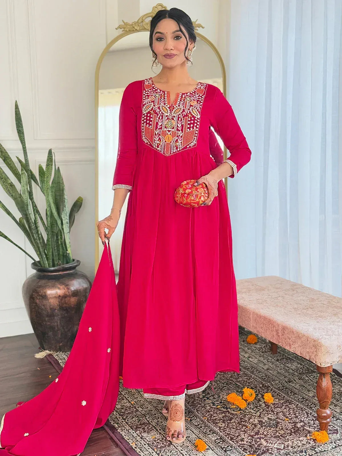 Vibrant pink embroidered ethnic gown with matching dupatta, perfect for Indian celebrations and festive occasions.