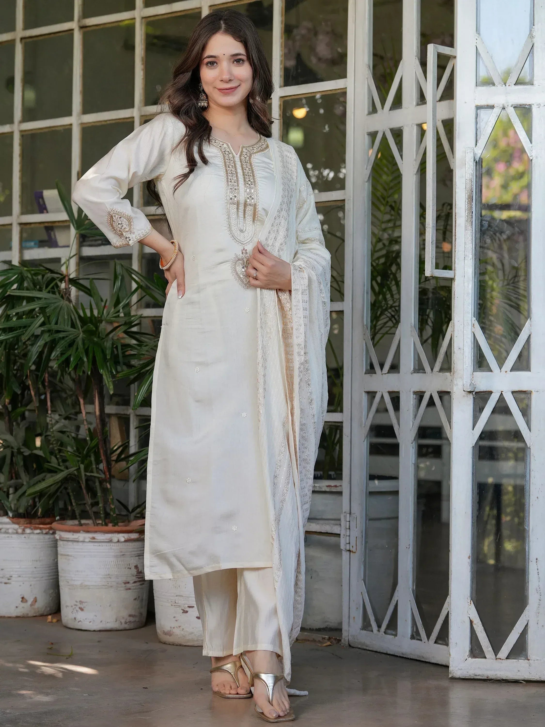 Elegant ivory salwar kameez with gold embroidery, perfect for Indian ethnic wear occasions.