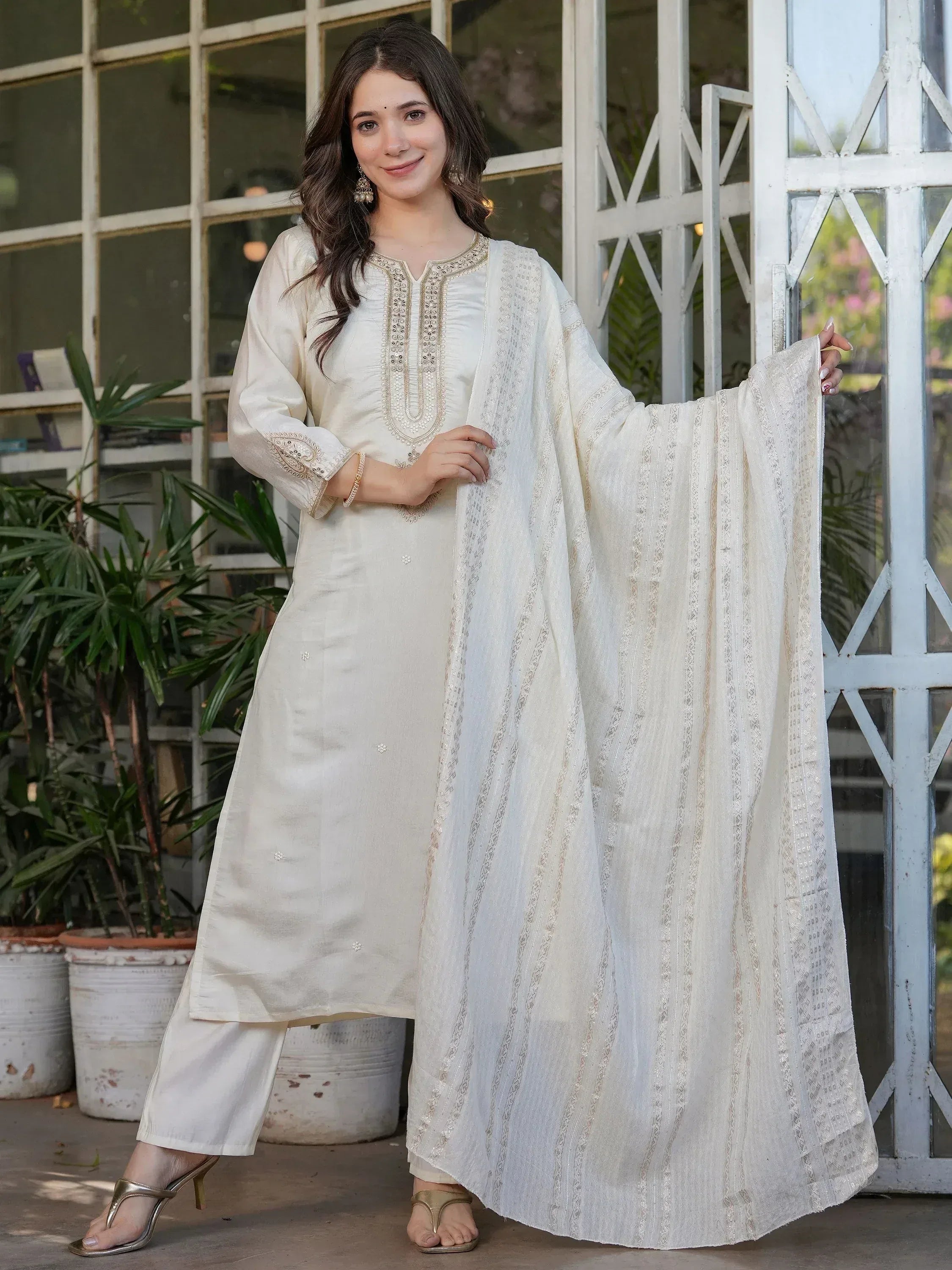 Elegant ivory ethnic salwar kameez with gold embroidery and sheer dupatta, perfect for Indian occasions.