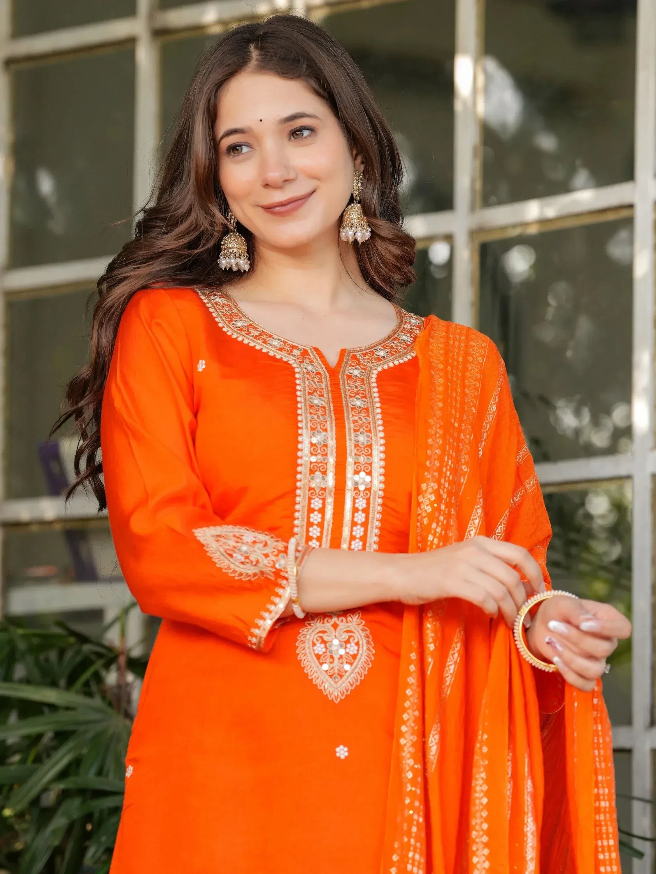 Orange embroidered salwar kameez with gold detailing, perfect for Indian ethnic wear occasions