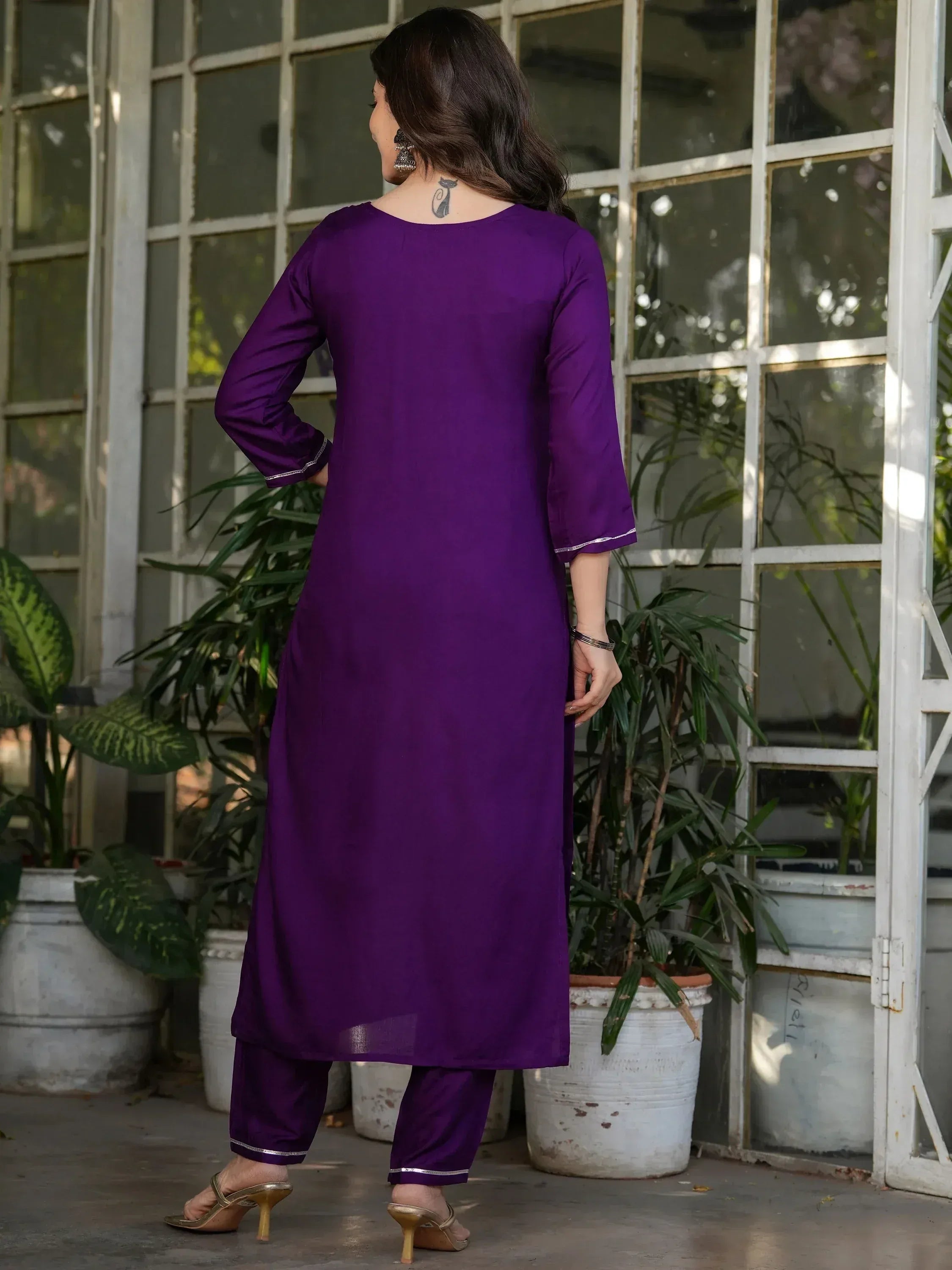 Purple ethnic kurta set with silver trim, styled with palazzo pants and heels, perfect for Indian occasions.
