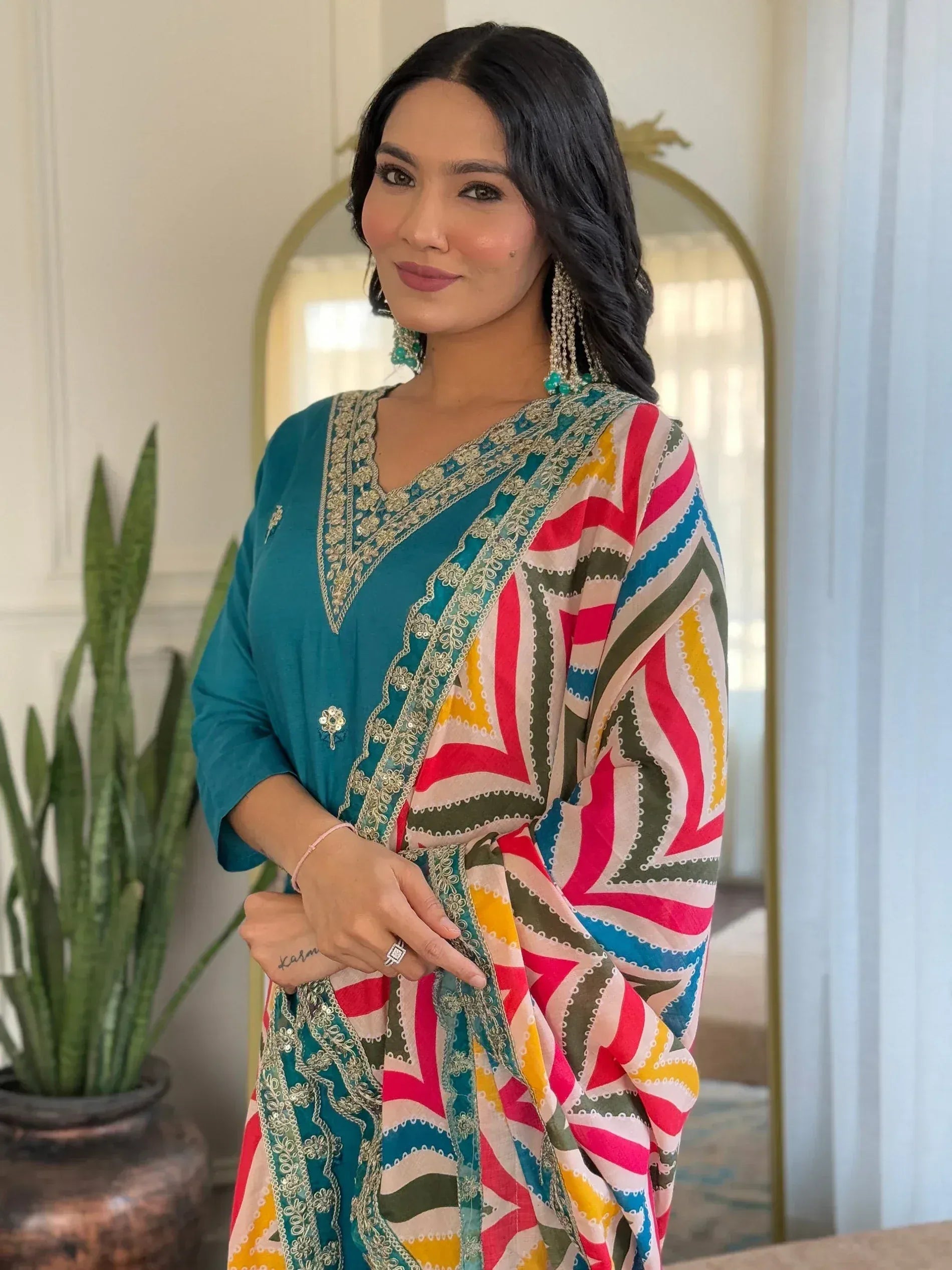 Woman in teal embroidered kurta with colorful geometric dupatta, Indian ethnic wear