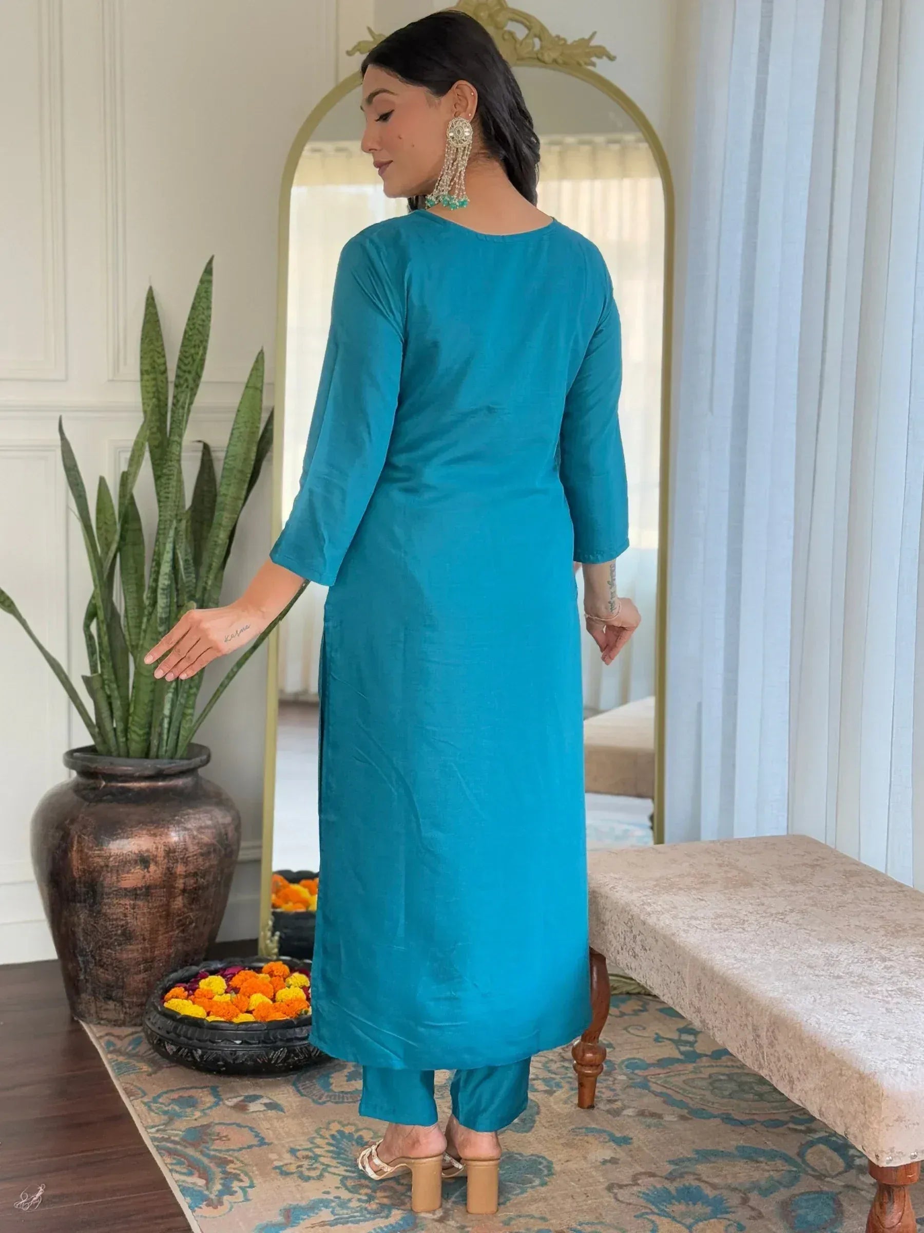 Teal Indian ethnic kurta with matching pants, styled with statement earrings for festive occasions