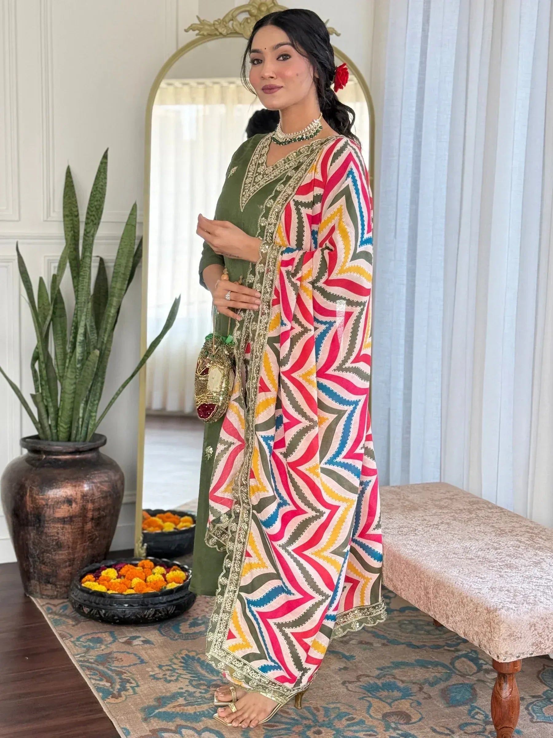 Woman in olive green embroidered kurta with colorful geometric dupatta, ethnic Indian wear