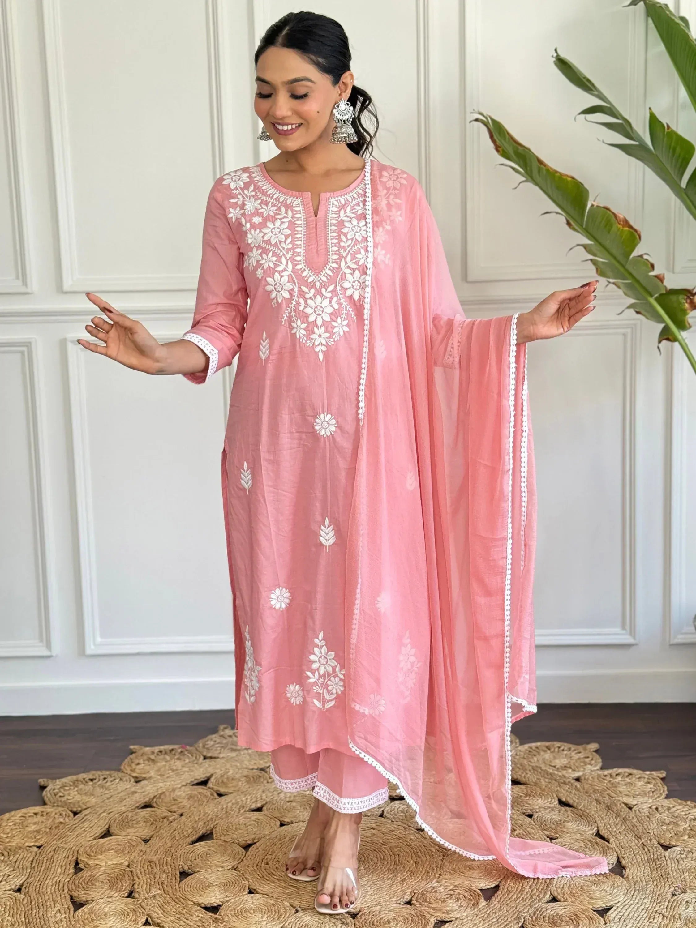 Pink embroidered salwar kameez with white floral work, perfect for Indian ethnic wear occasions