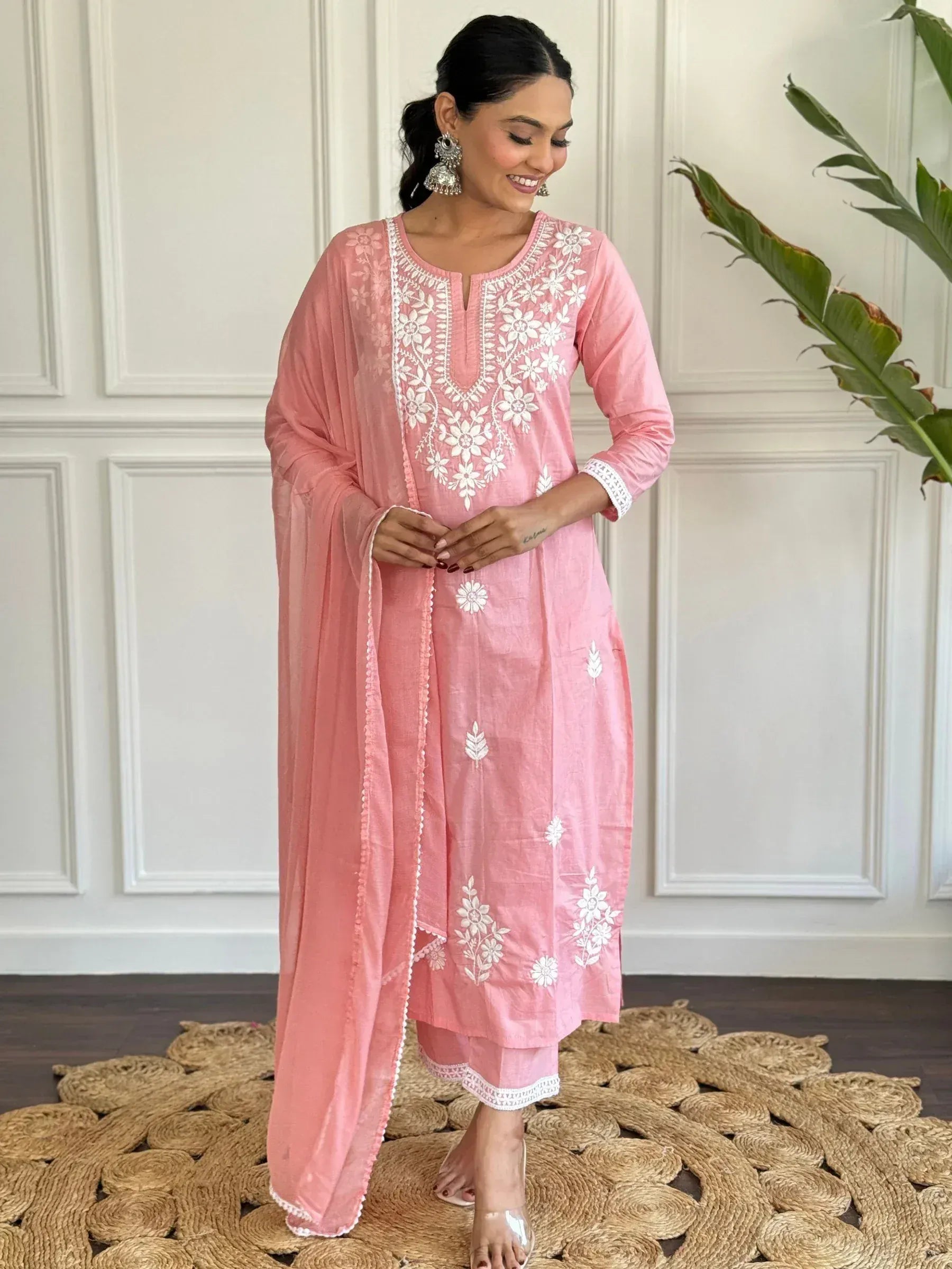 Pink embroidered salwar kameez with white floral detailing, perfect for ethnic wear and festive occasions.