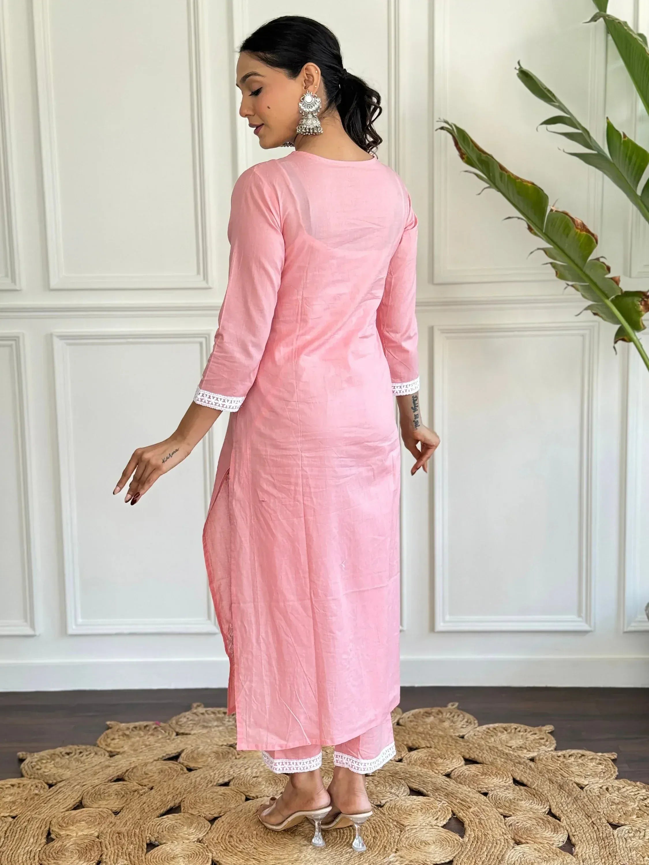 Pink ethnic kurta with white embroidery, paired with matching pants, perfect for Indian wear