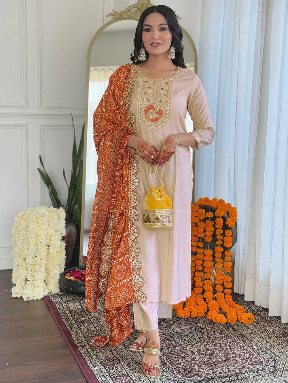 Woman in beige embroidered kurta with orange printed dupatta, ethnic Indian wear for festive occasions
