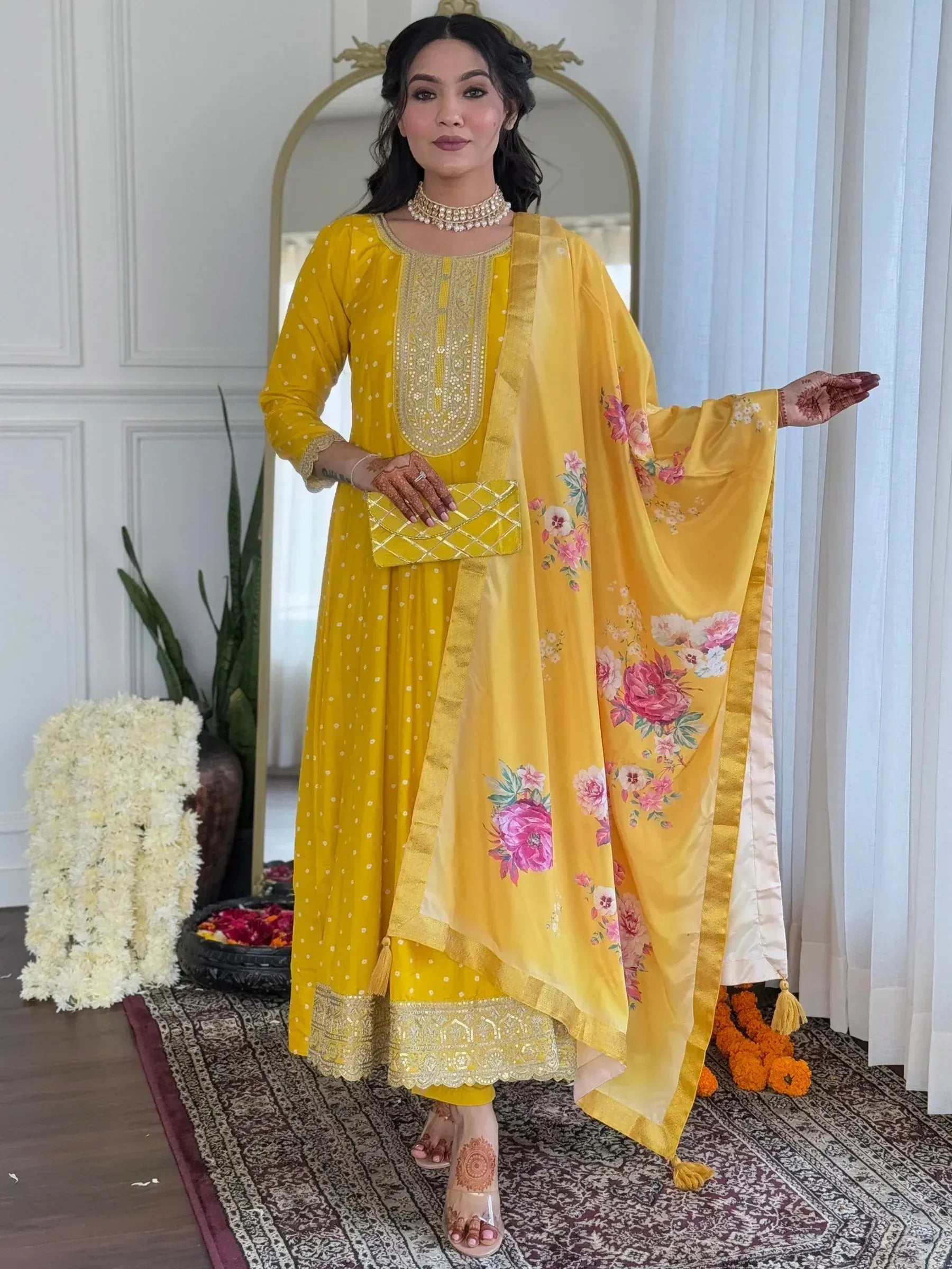 Yellow floral printed salwar kameez with gold embroidery, perfect for Indian ethnic wear occasions.