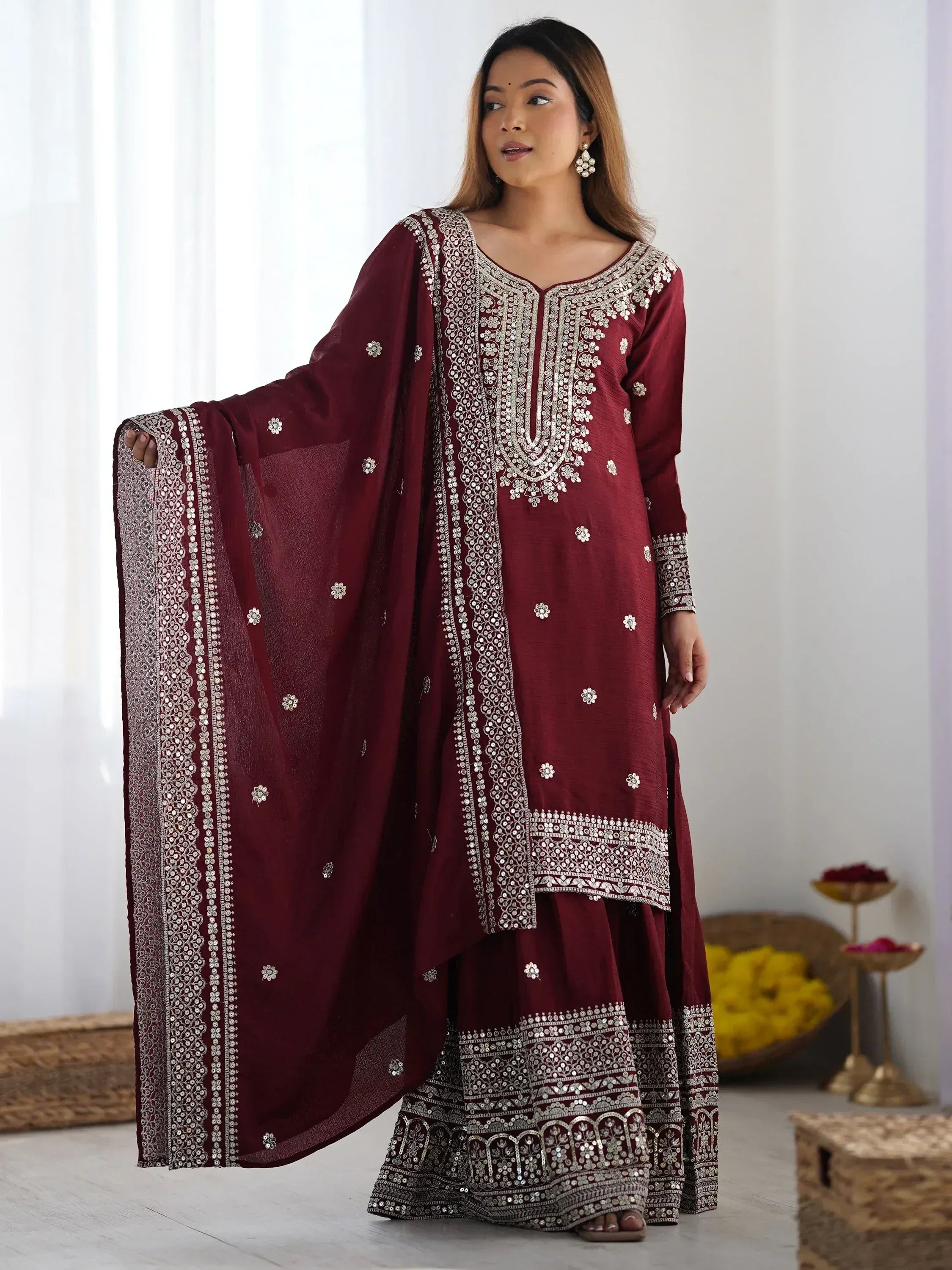 Maroon embroidered salwar kameez with mirror work, perfect for Indian ethnic wear and festive occasions.