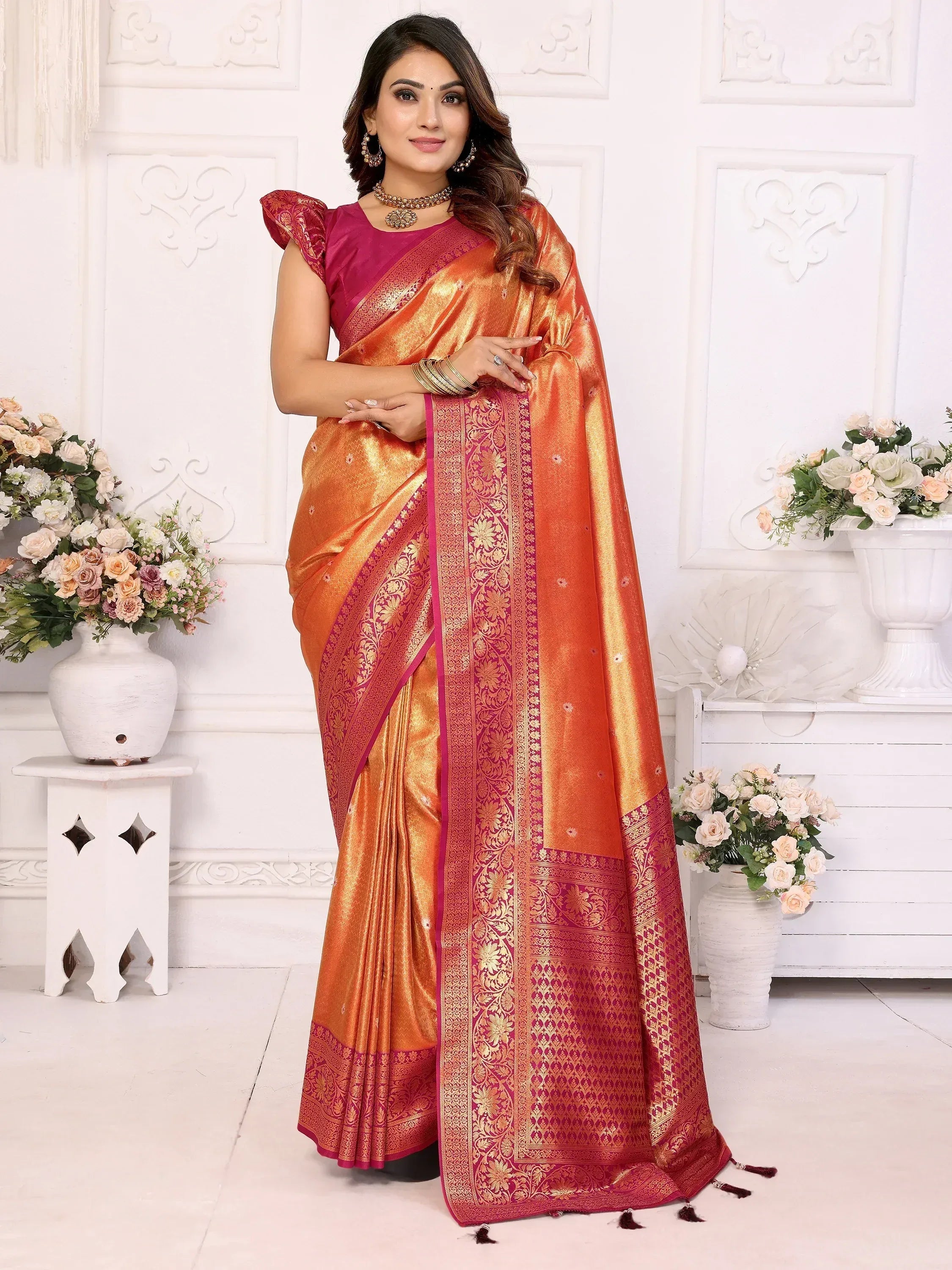 Orange and pink designer saree with gold zari border, perfect for weddings and festive occasions