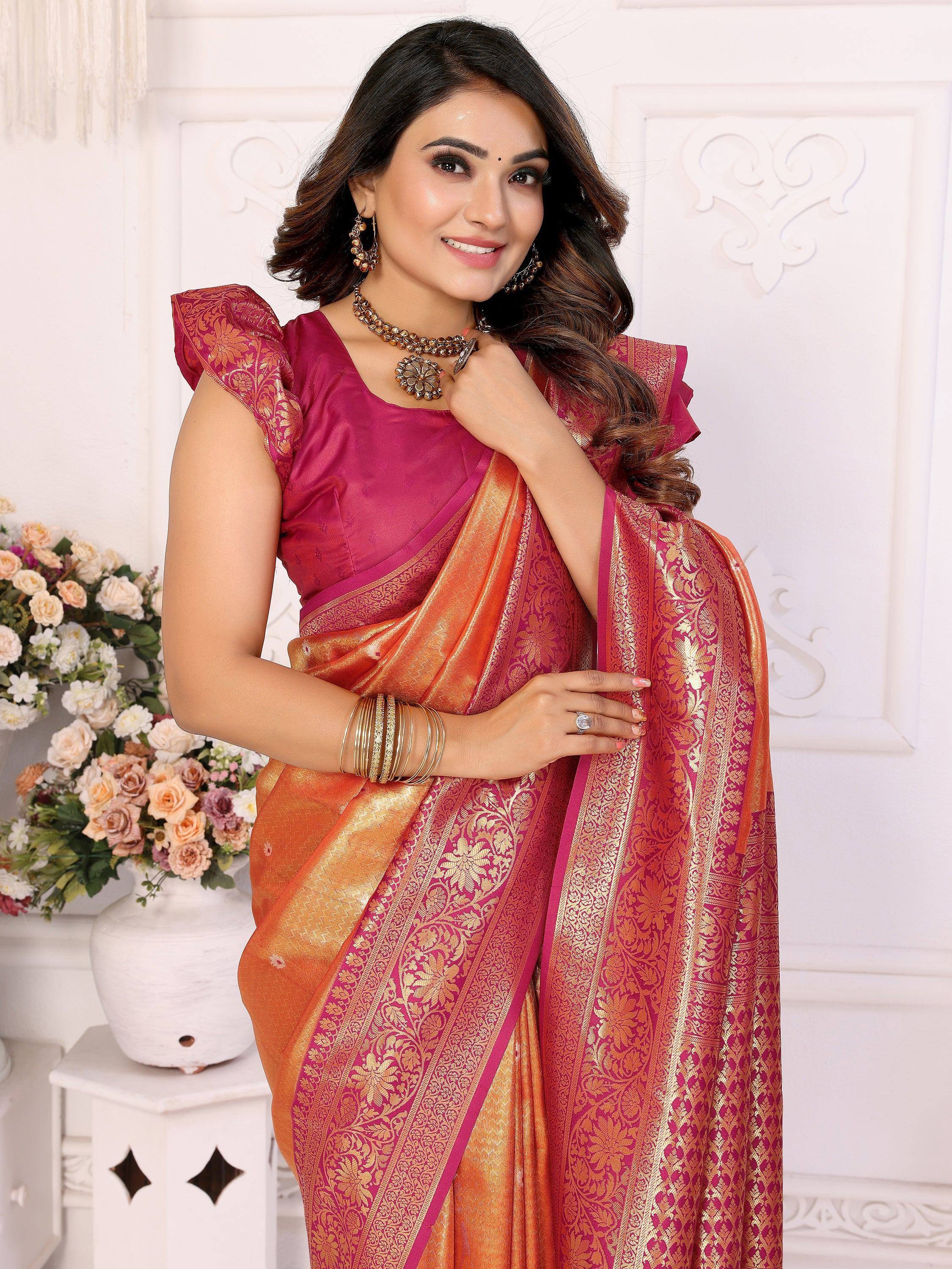 Elegant pink and orange saree with gold embroidery, styled with traditional jewelry for festive occasions.