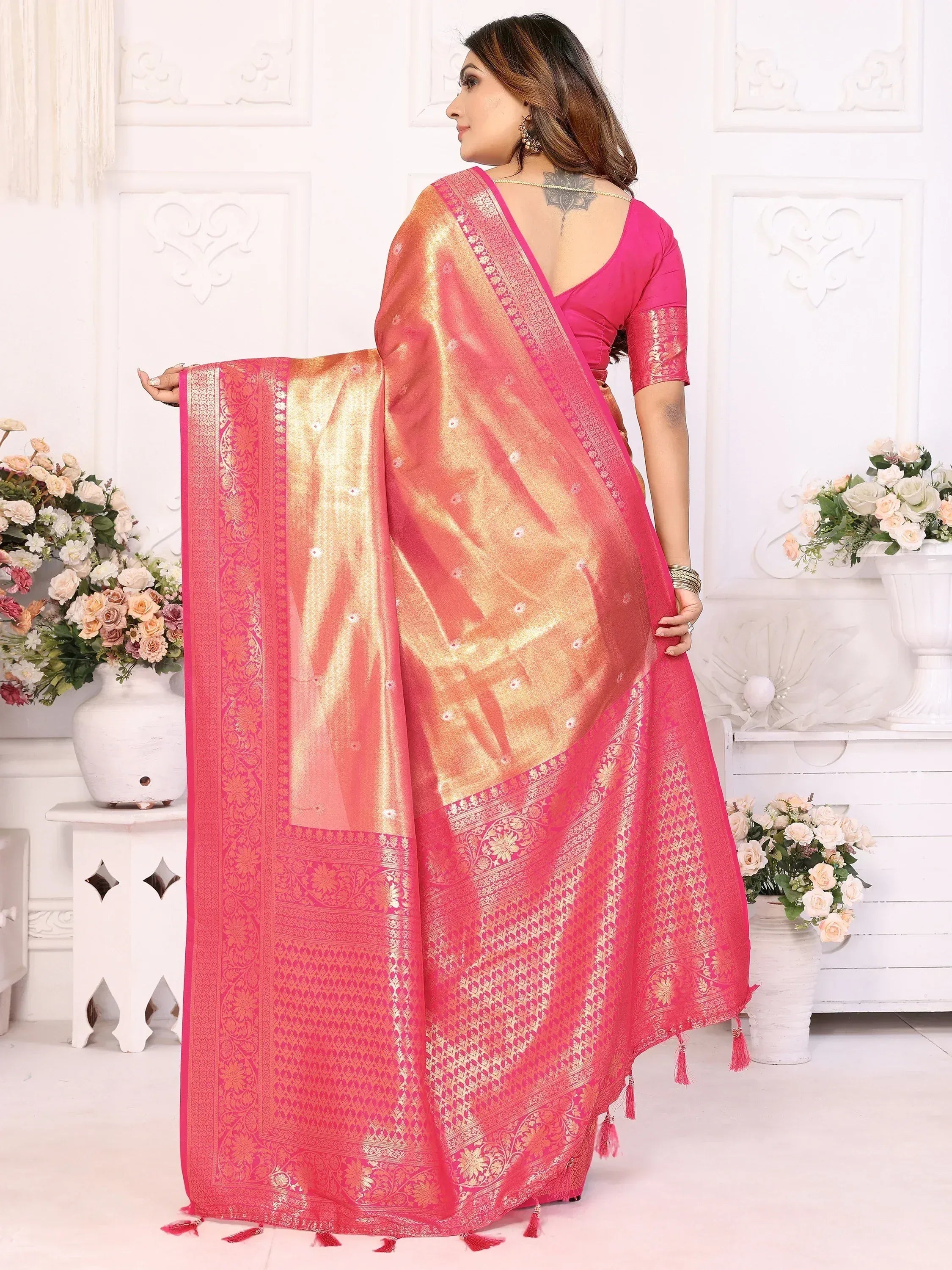 Pink and gold designer saree with intricate embroidery and tassels, perfect for Indian ethnic wear occasions.