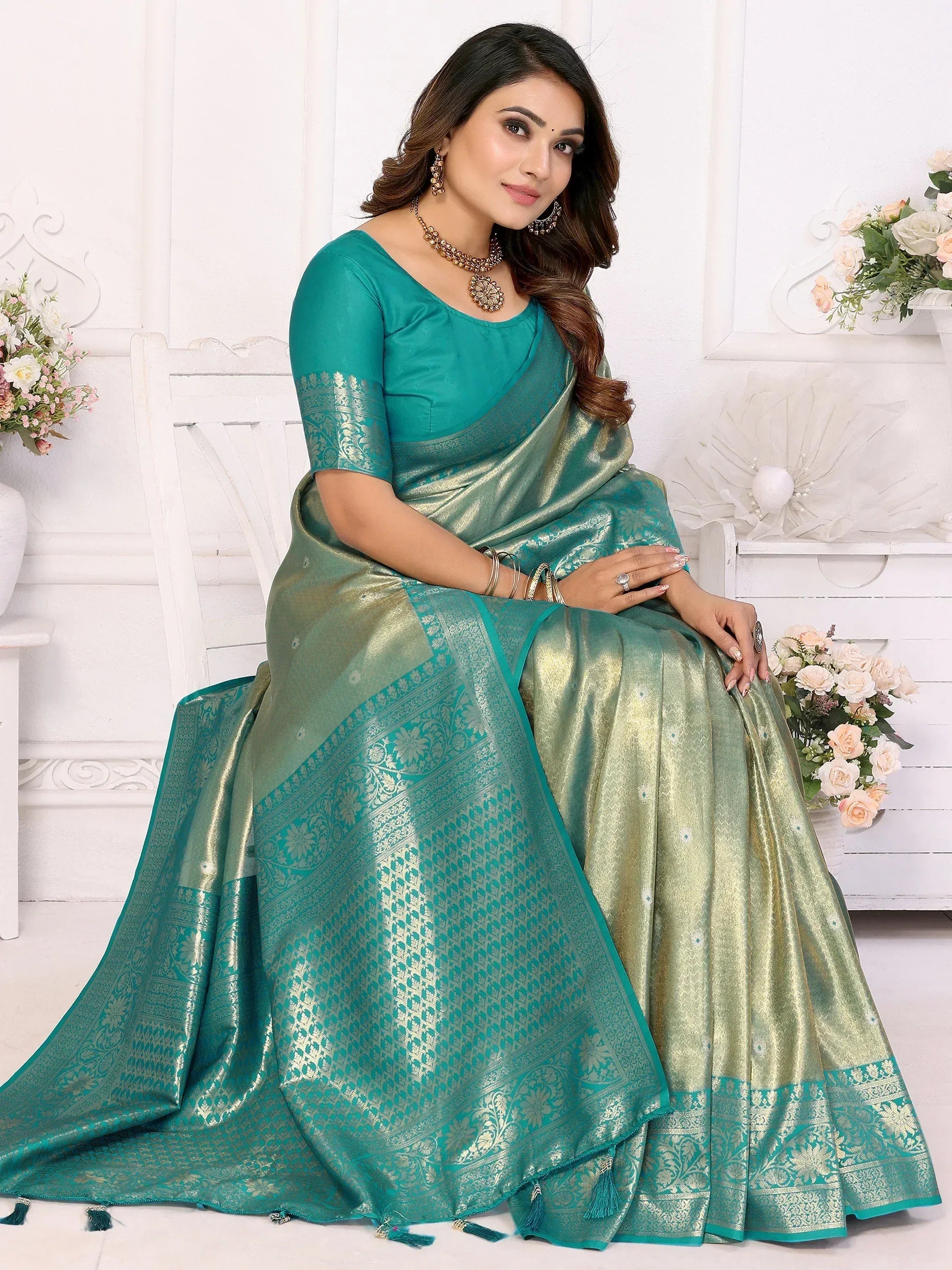 Elegant teal and gold saree with intricate patterns, perfect for ethnic occasions