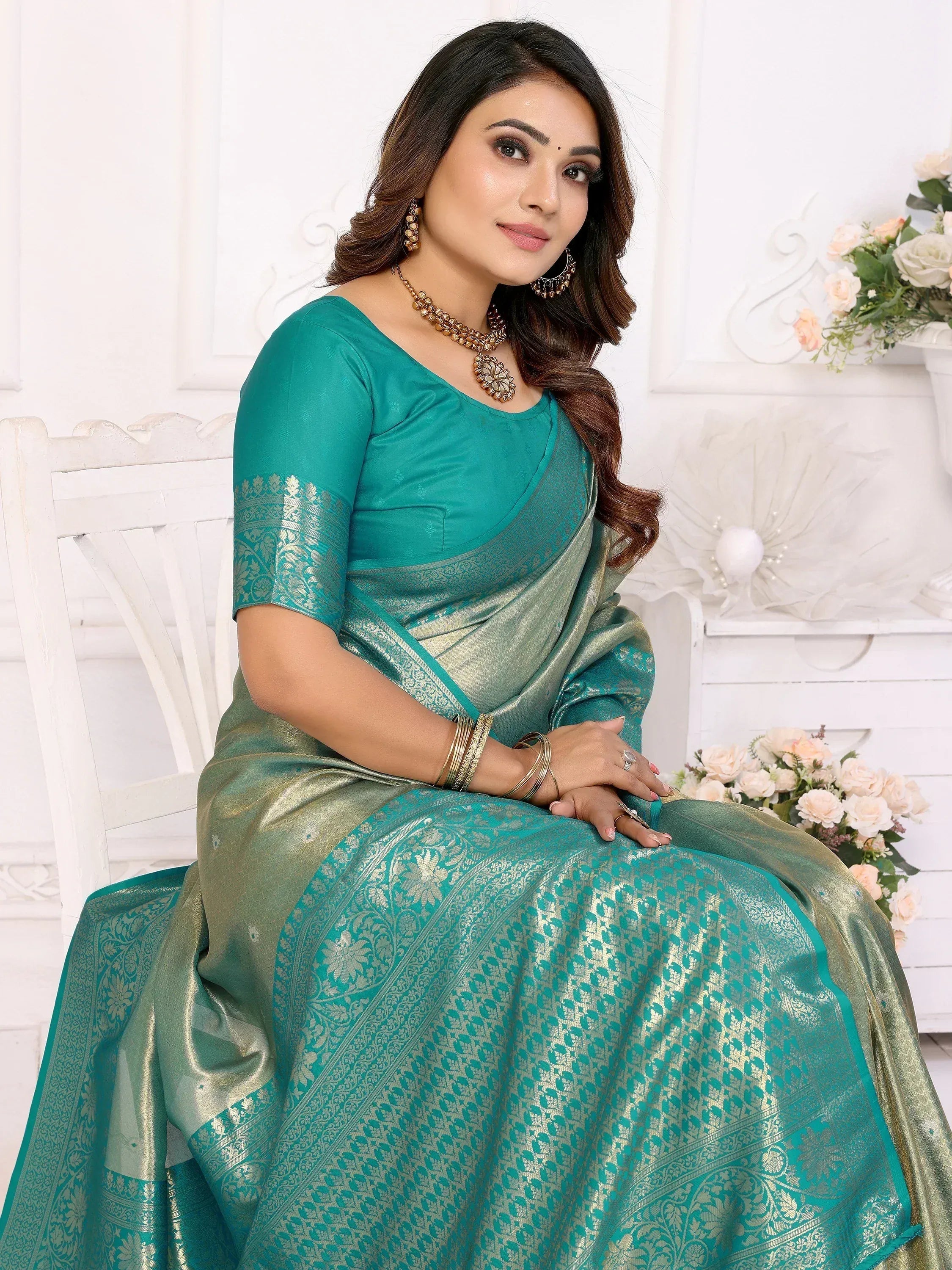 Elegant teal saree with golden floral patterns, perfect for Indian ethnic wear occasions.