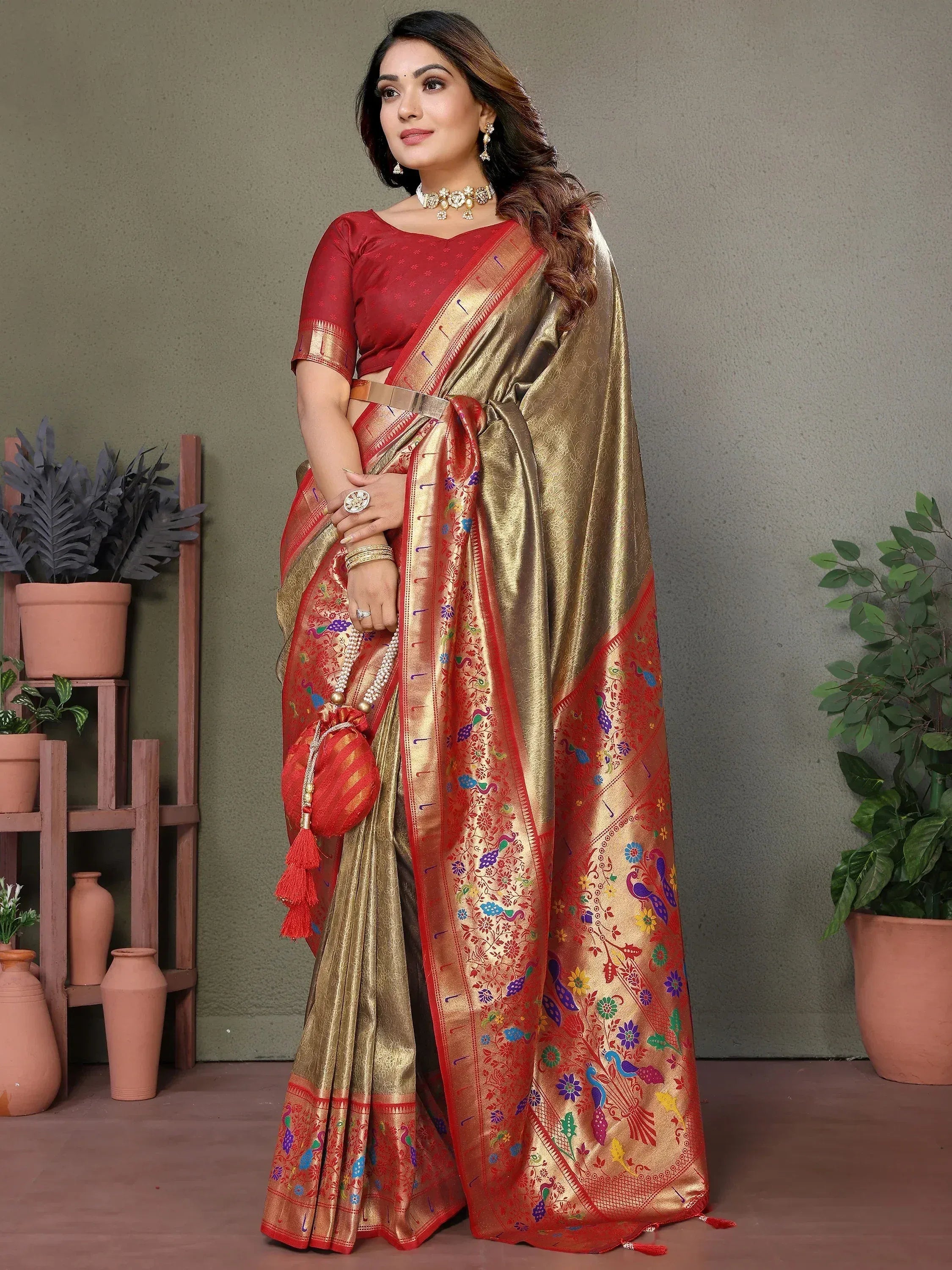 Elegant red and gold saree with peacock embroidery, perfect for Indian ethnic wear occasions.