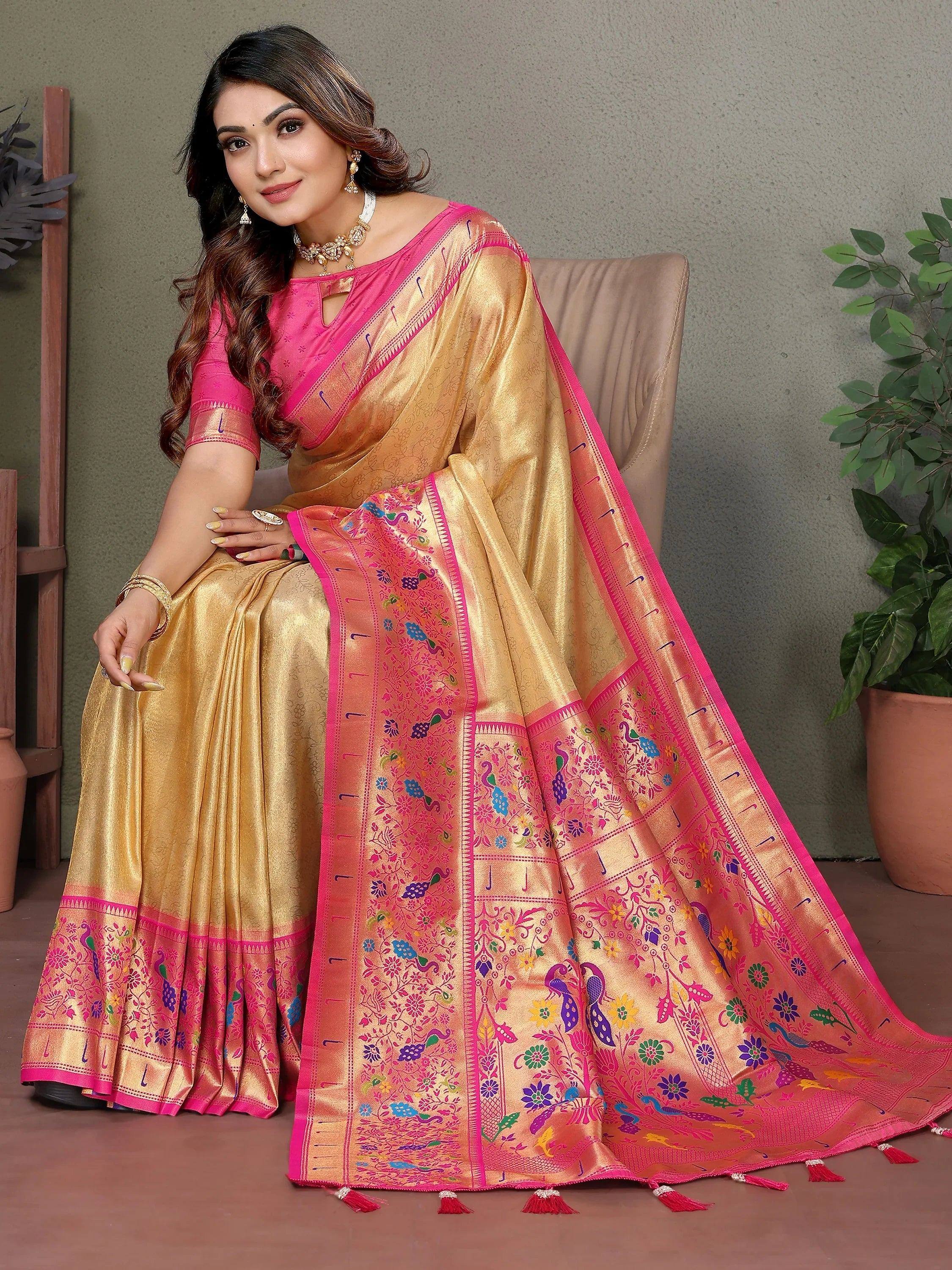 Golden saree with pink border and peacock embroidery, paired with matching blouse for festive occasions