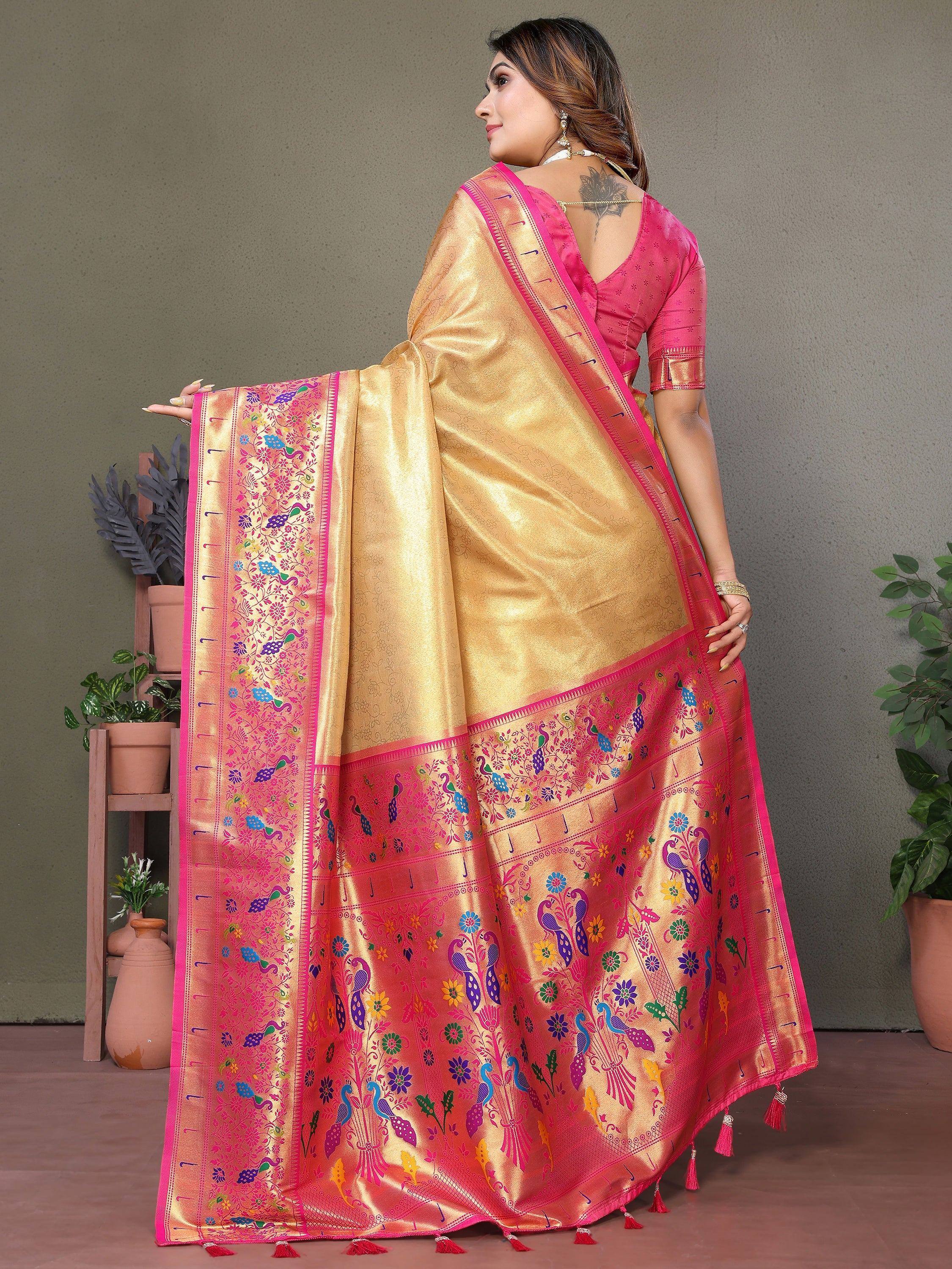 Golden saree with pink border and peacock embroidery, paired with a pink blouse, perfect for ethnic occasions.