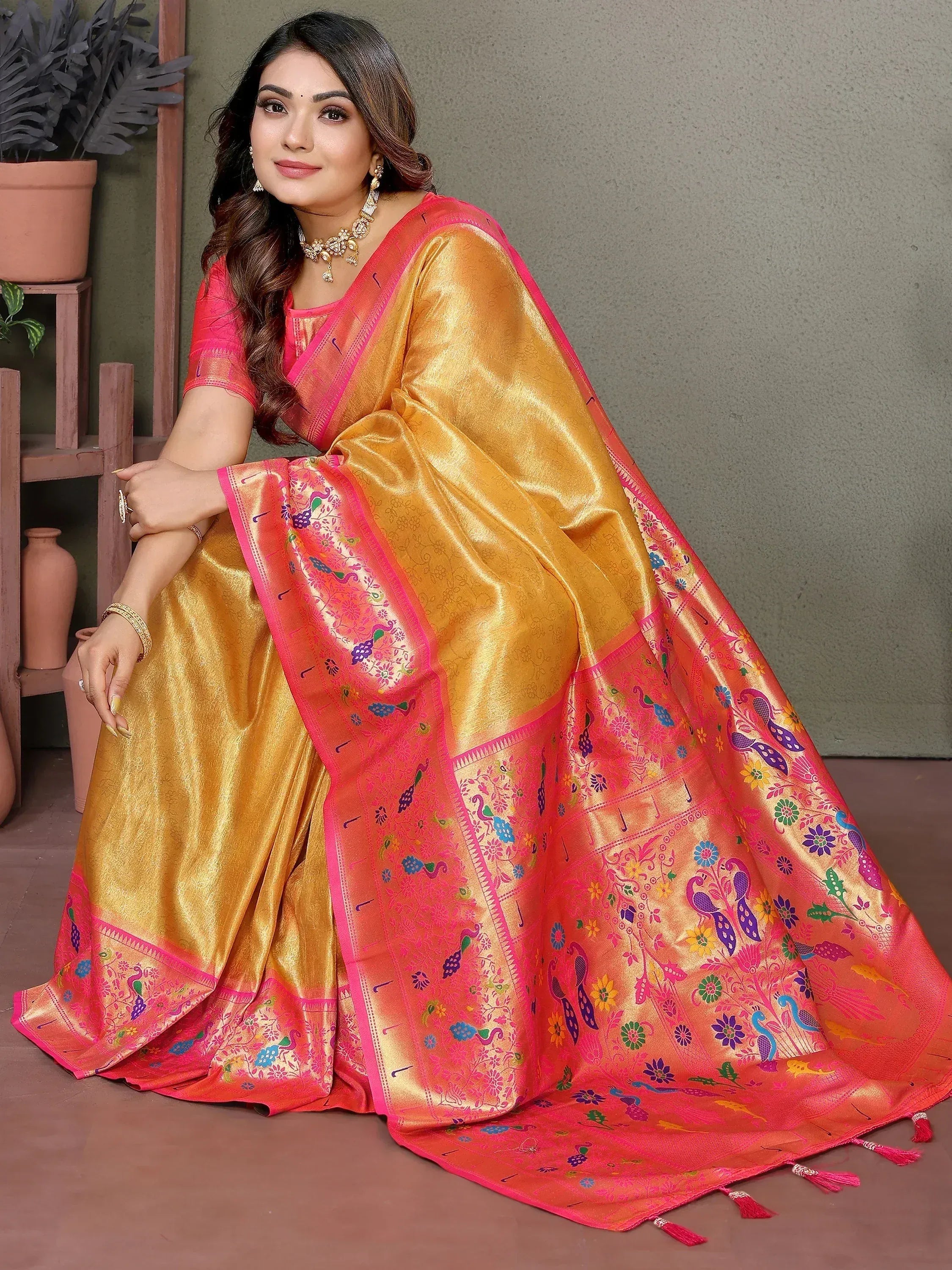 Golden and pink designer saree with peacock and floral motifs, perfect for ethnic occasions