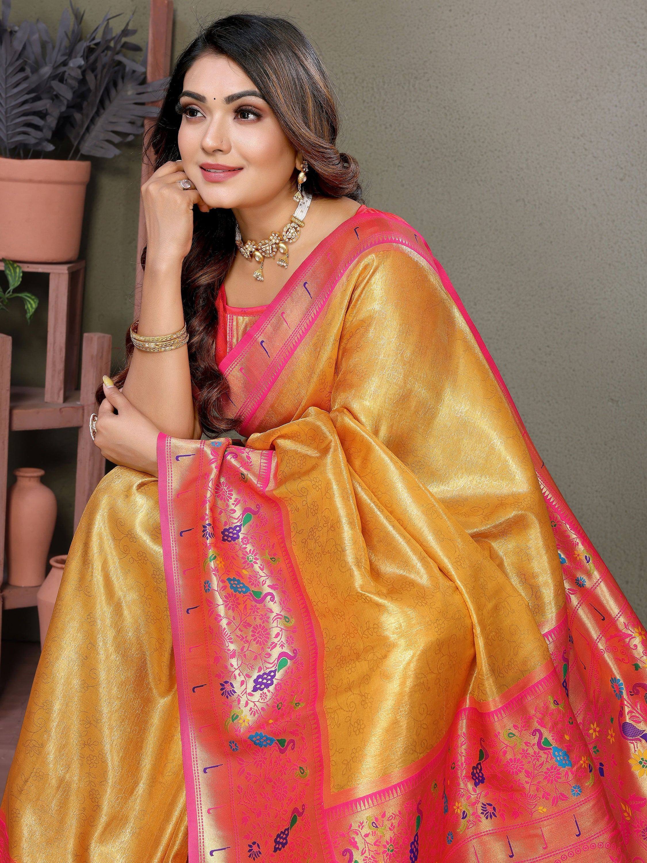 Golden saree with pink border and peacock embroidery, perfect for ethnic occasions