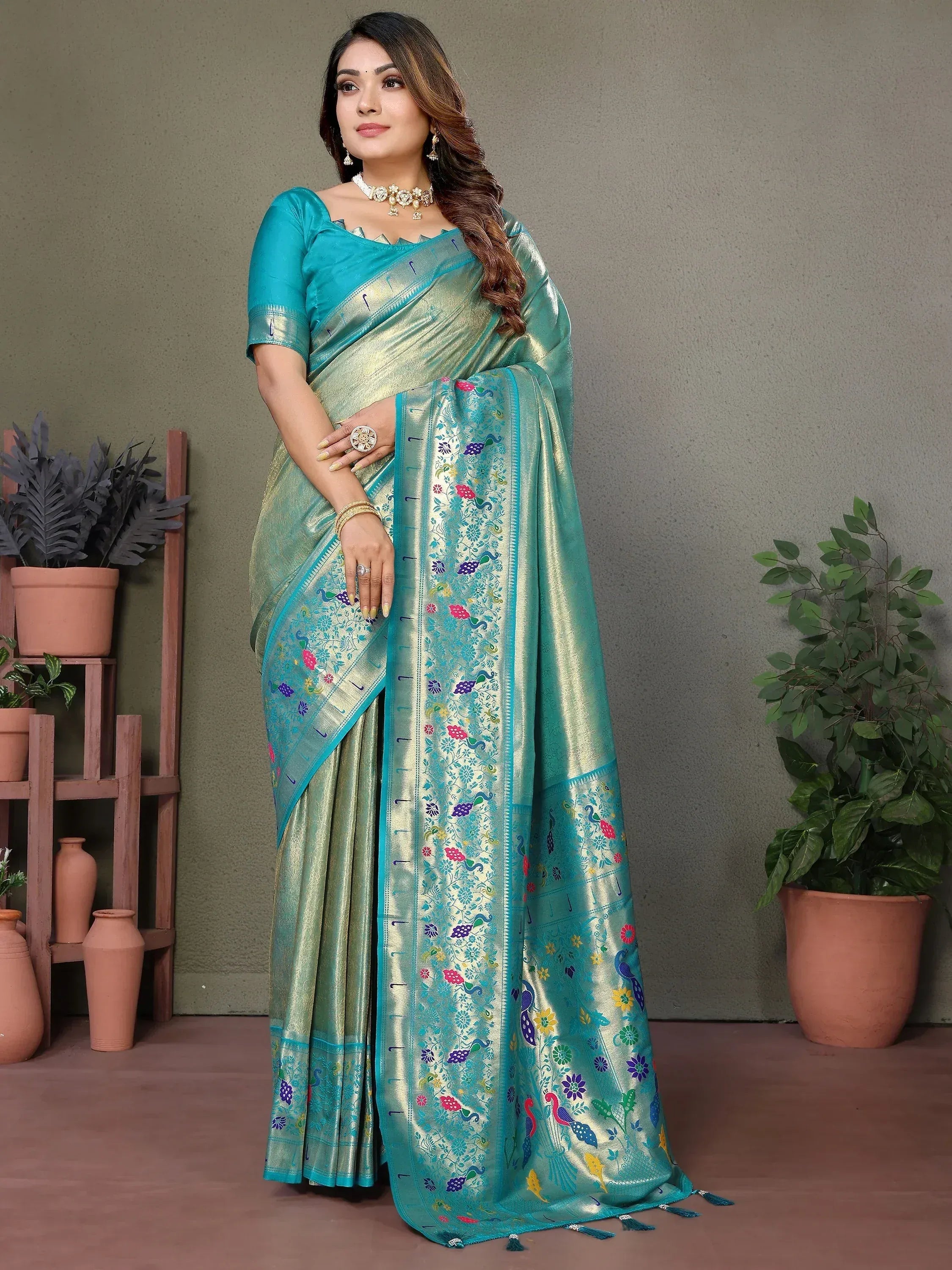 Elegant turquoise saree with floral and peacock embroidery, perfect for Indian ethnic wear occasions.
