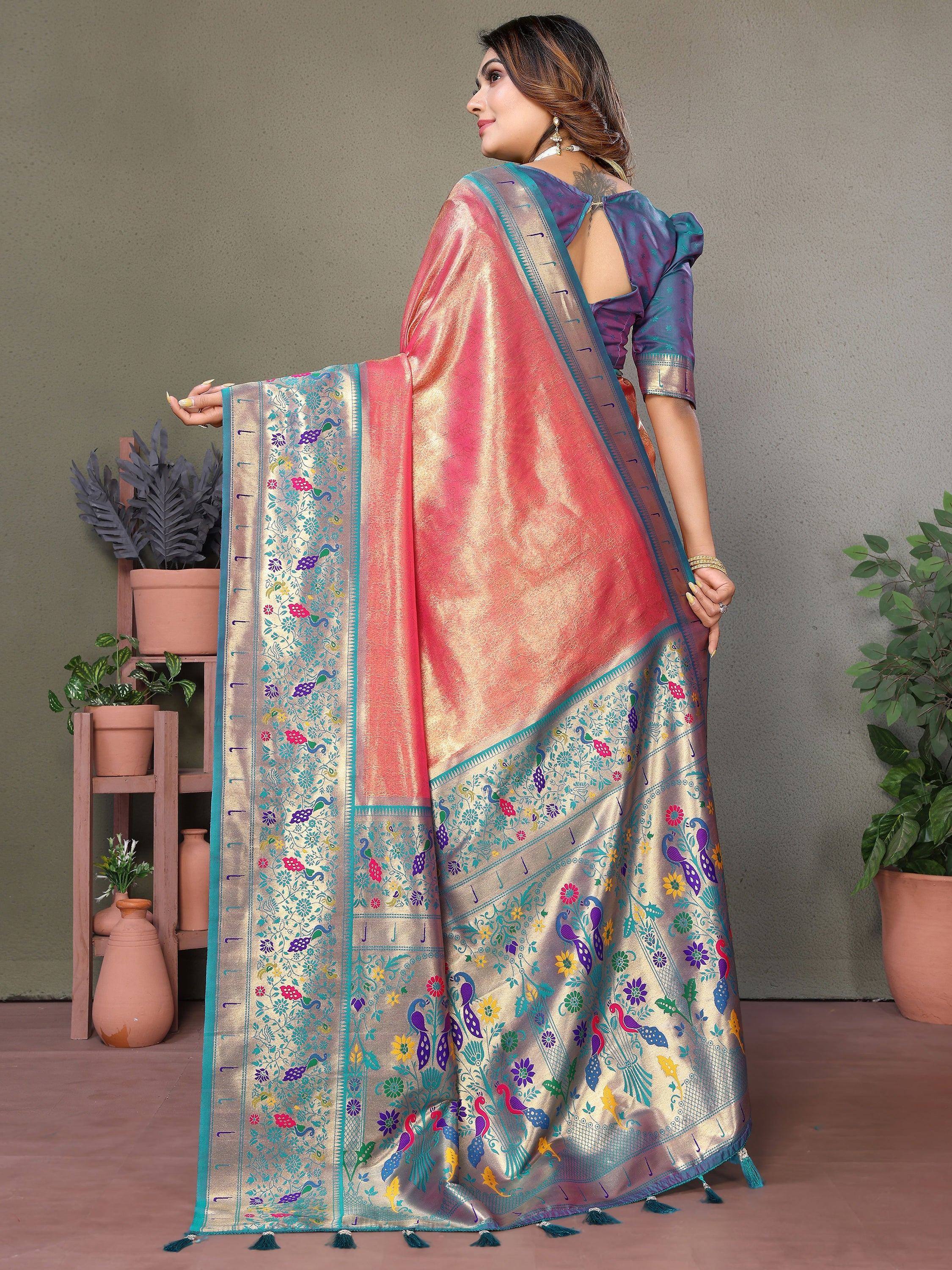 Elegant peacock-print saree with vibrant floral borders and golden sheen, paired with a purple blouse.