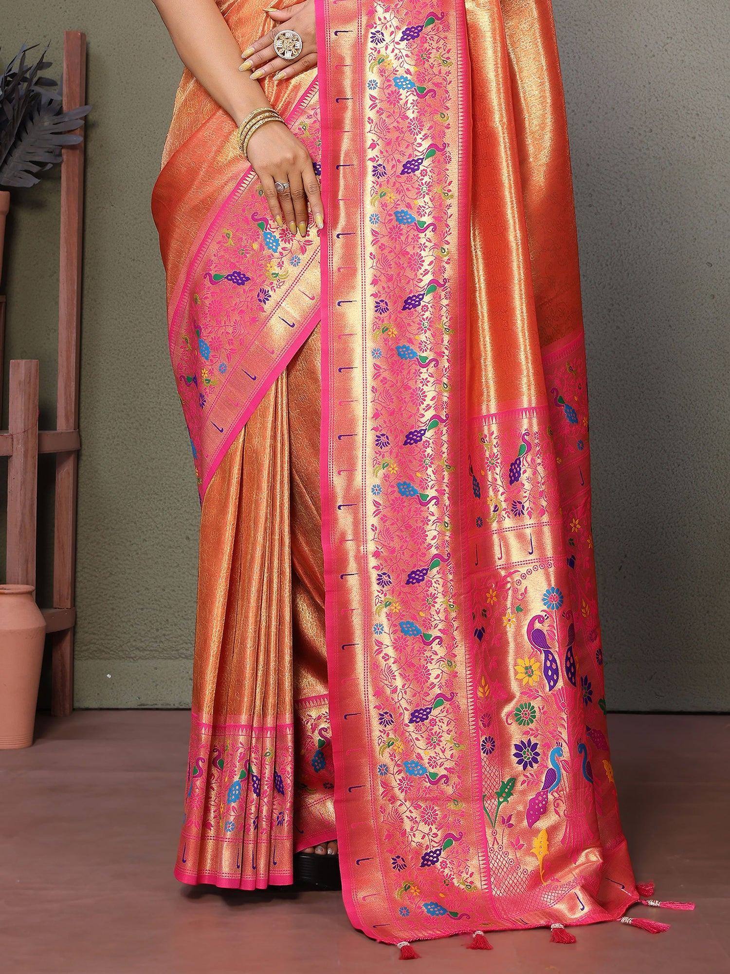 Orange and pink embroidered saree with peacock motifs and floral designs, perfect for festive occasions.