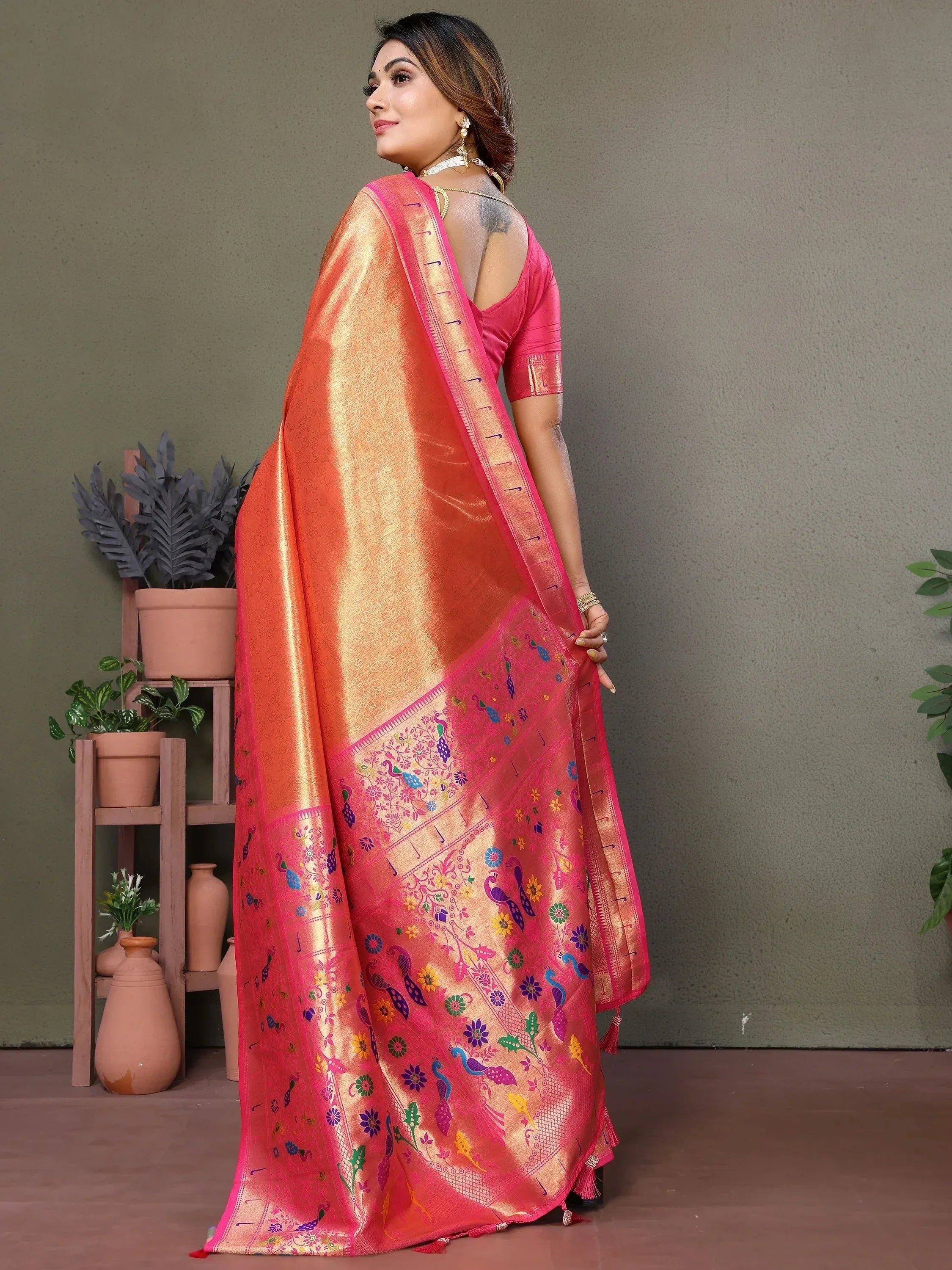 Vibrant pink and orange saree with peacock and floral embroidery, perfect for Indian ethnic wear.