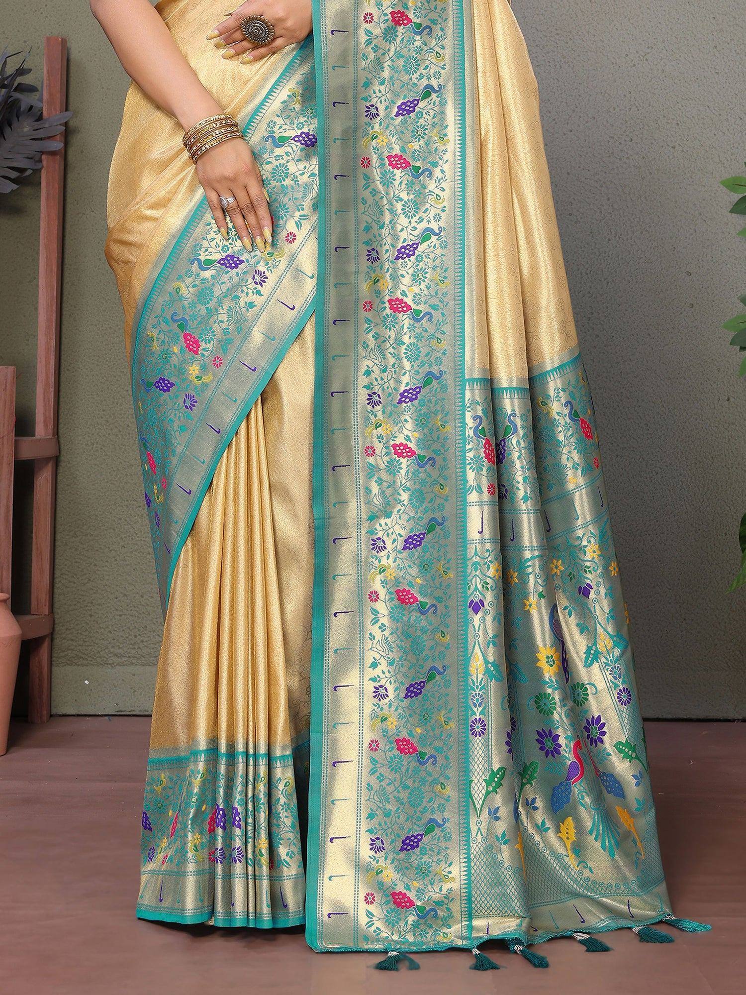 Golden saree with turquoise border, floral peacock motifs, and tassels for ethnic wear
