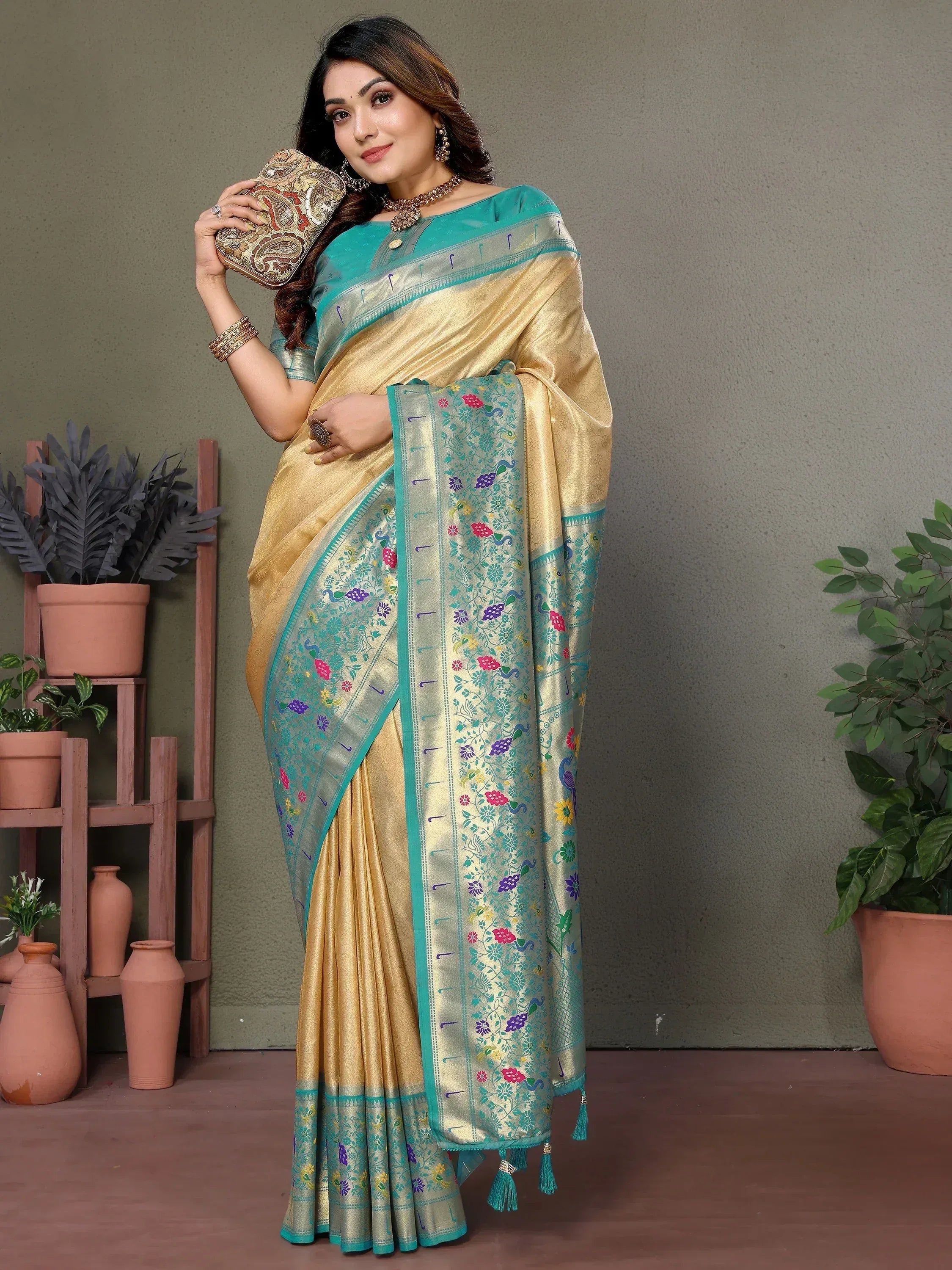 Elegant gold and teal saree with floral peacock motifs, perfect for Indian ethnic wear occasions.