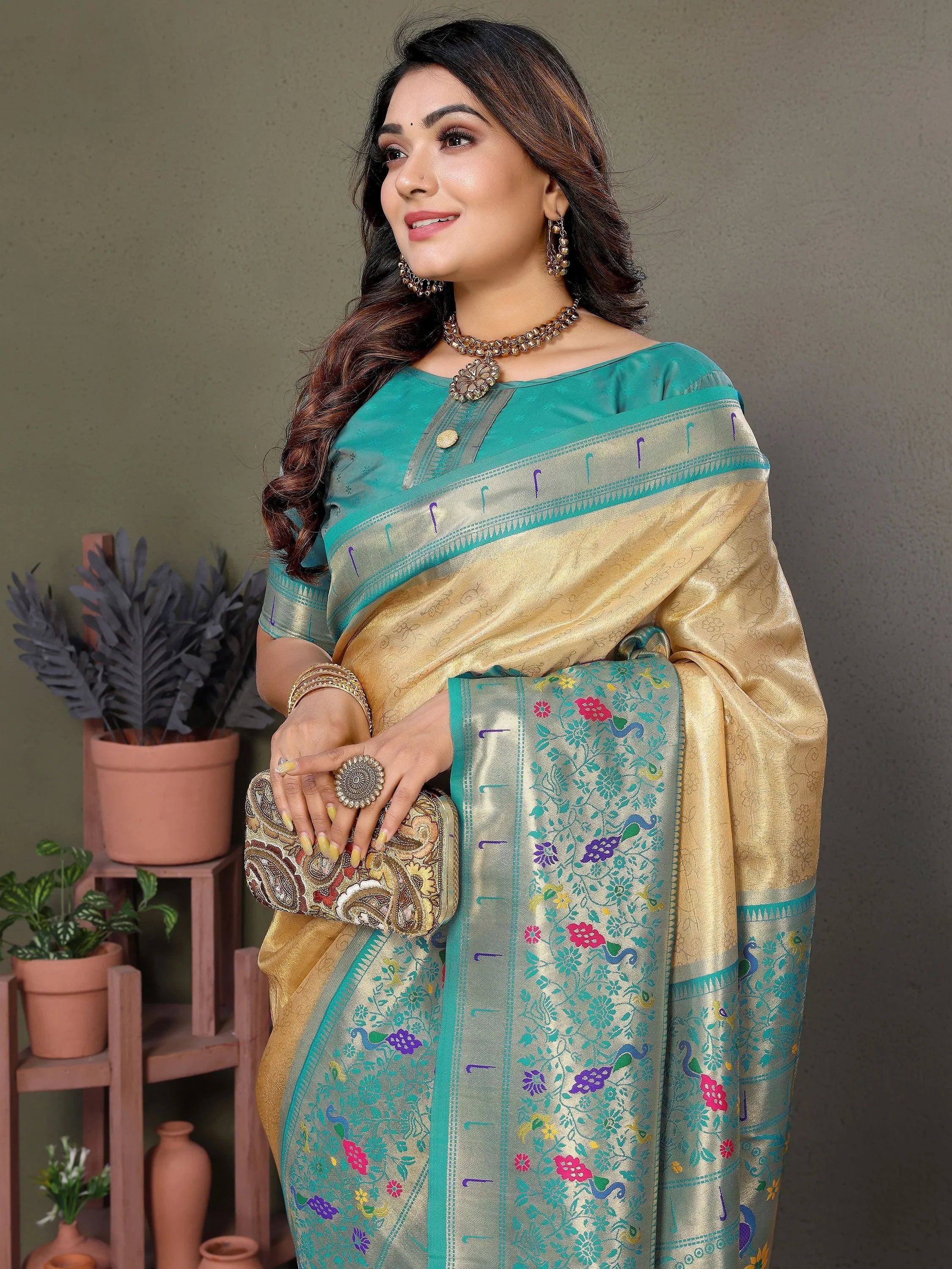 Elegant teal and gold saree with floral peacock motifs, perfect for Indian ethnic wear