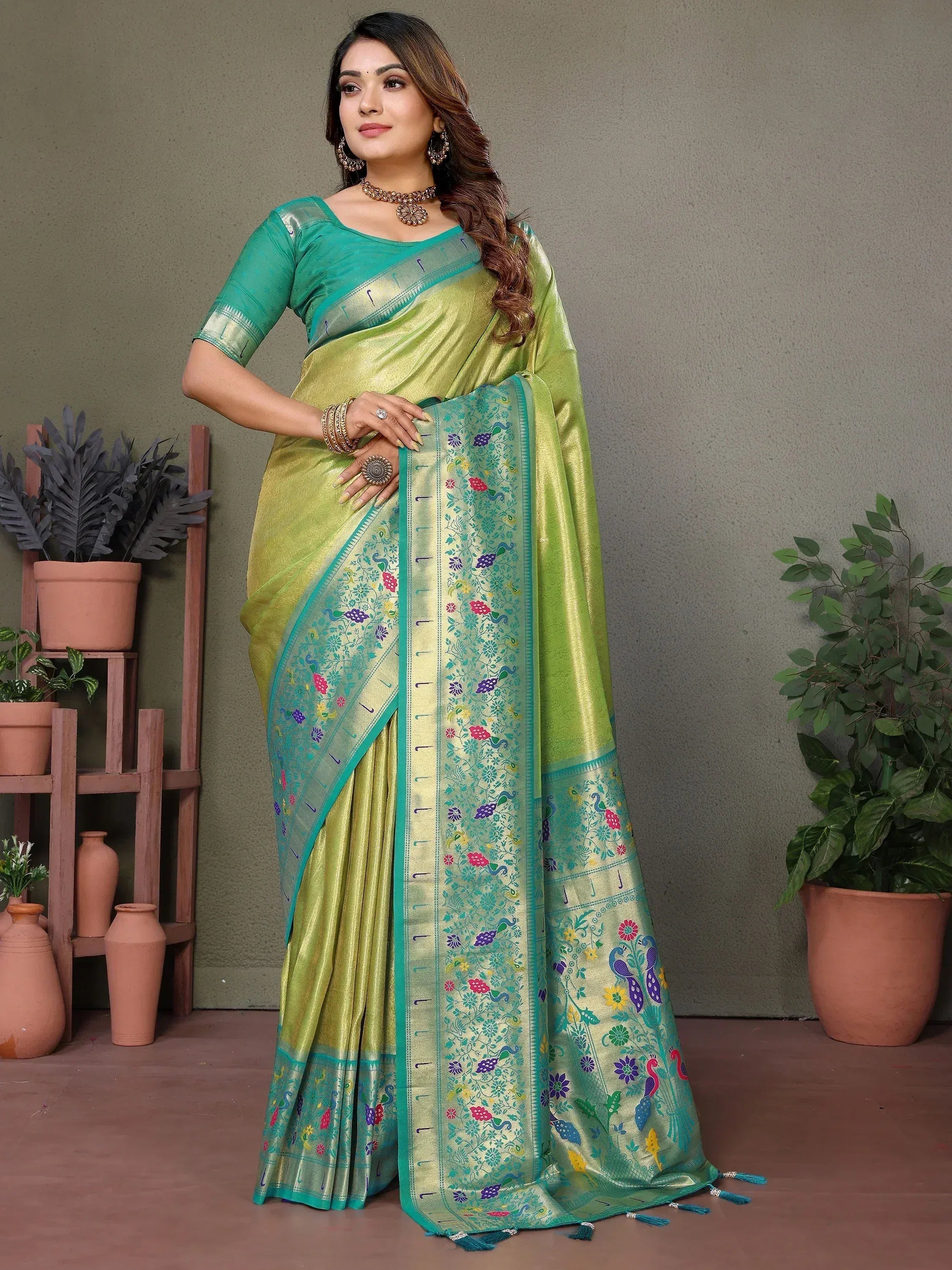 Green silk saree with peacock and floral embroidery, perfect for ethnic occasions