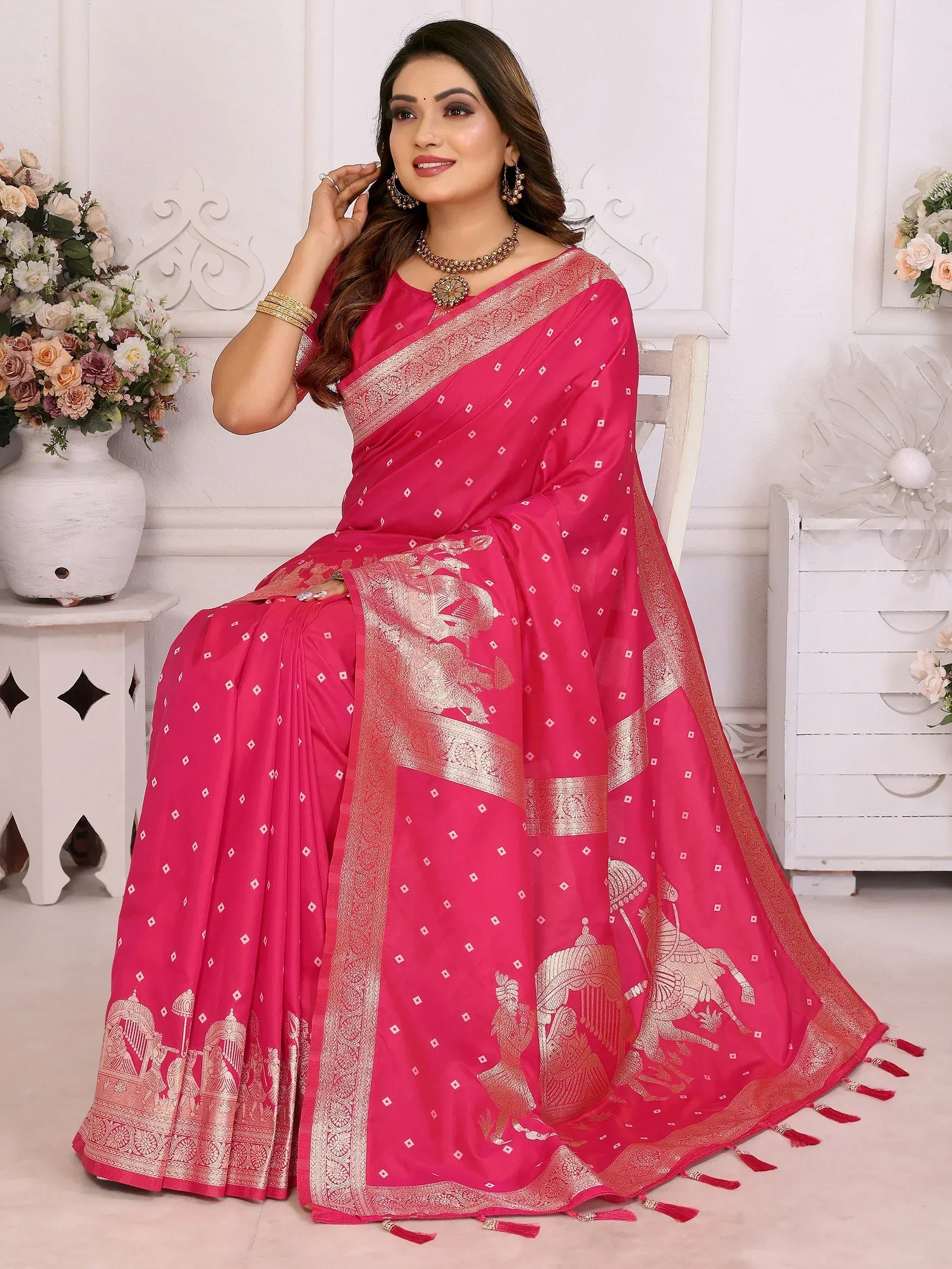 Pink ethnic saree with gold elephant motifs and zari border, perfect for Indian occasions