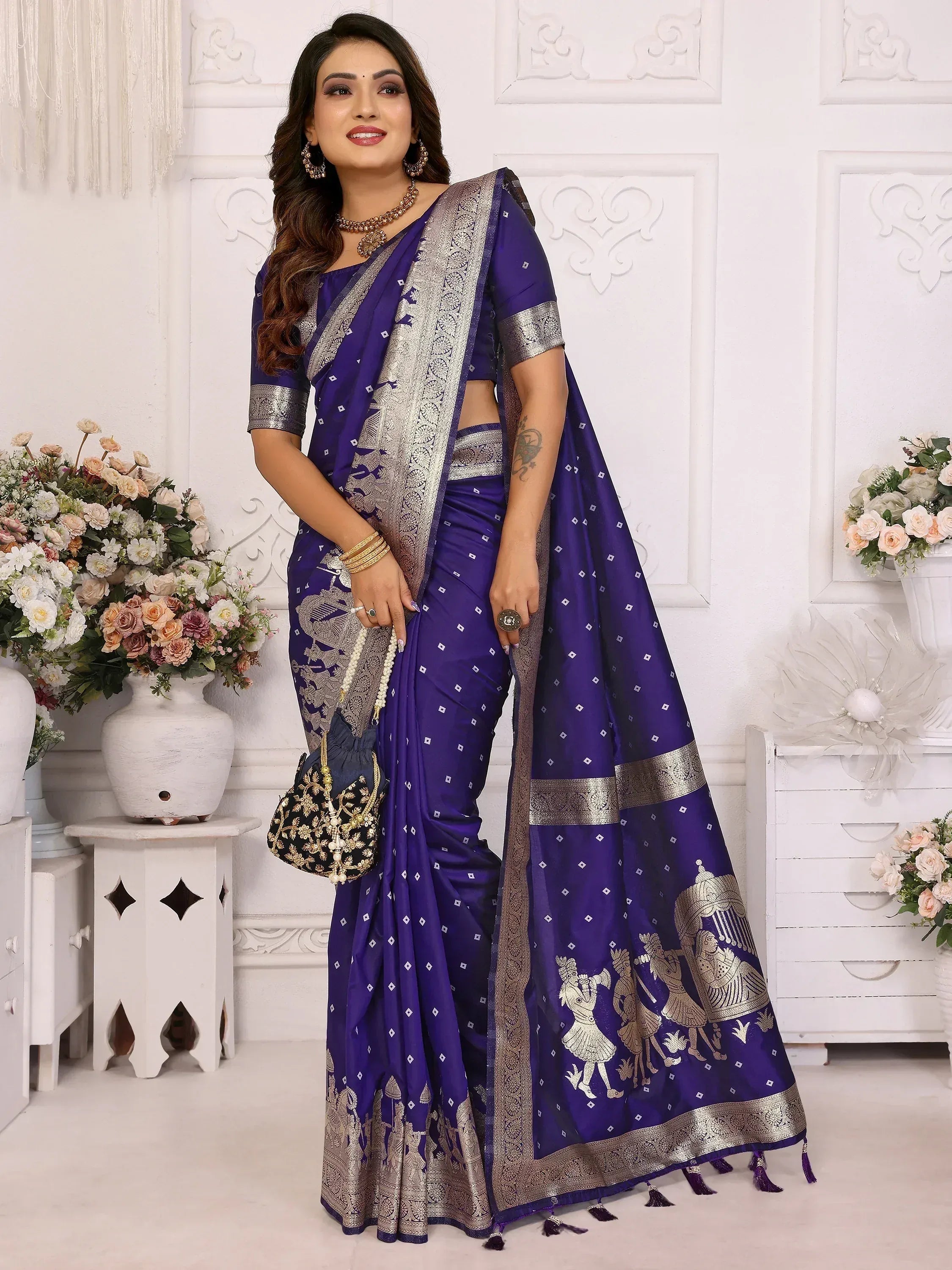 Elegant purple saree with gold embroidery and traditional Indian motifs, perfect for festive occasions.