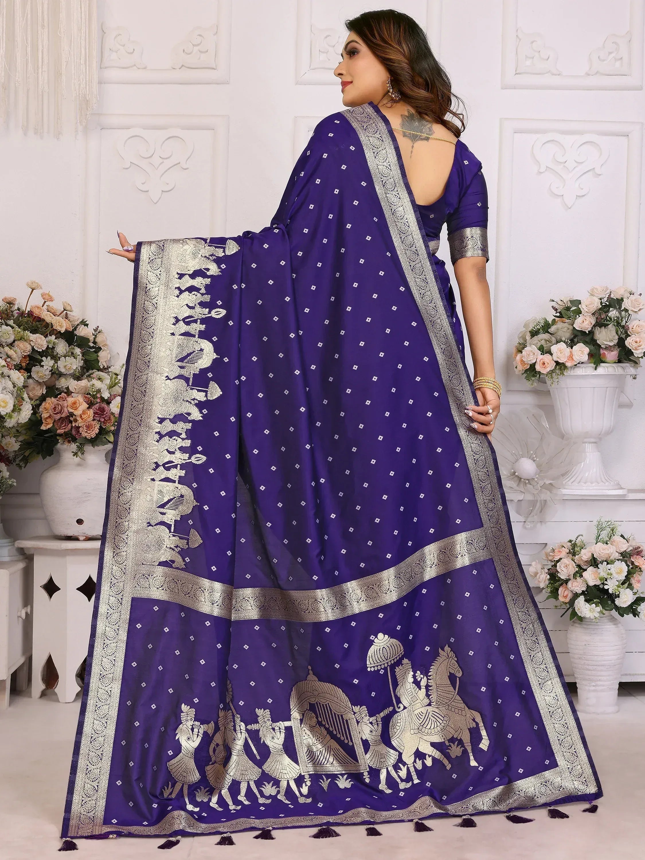 Purple silk saree with silver zari border and royal procession motifs, perfect for Indian ethnic occasions.