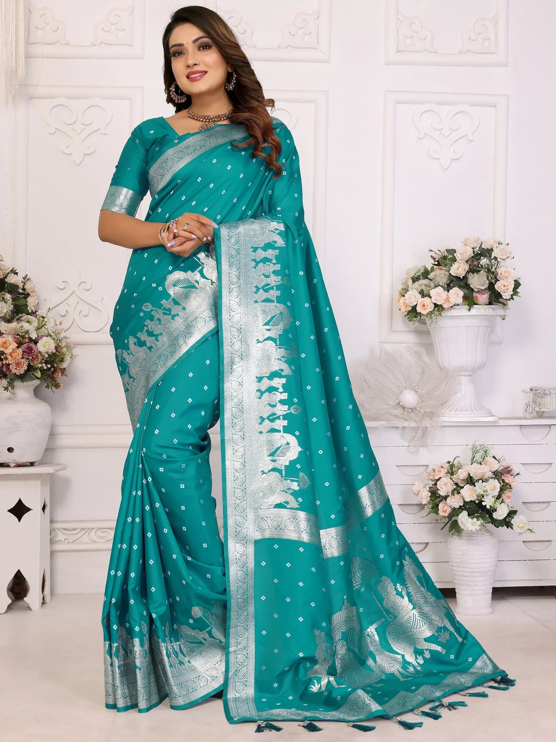 Teal saree with silver elephant motifs and intricate border, perfect for ethnic occasions